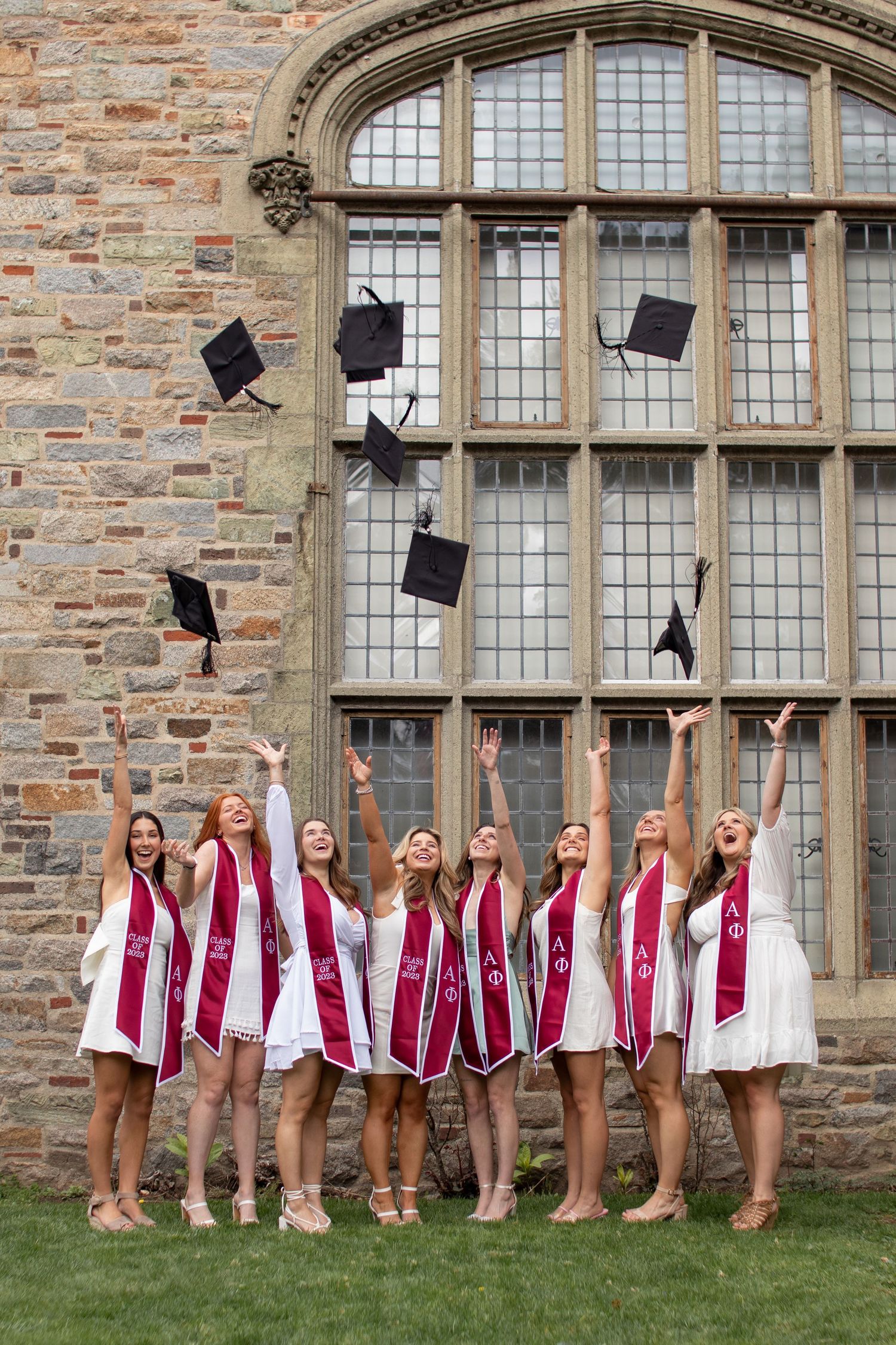 College friends graduation photos, natural lighting photography, WPI, sorority, senior grad photos. Worcester, MA. Caps in the air.