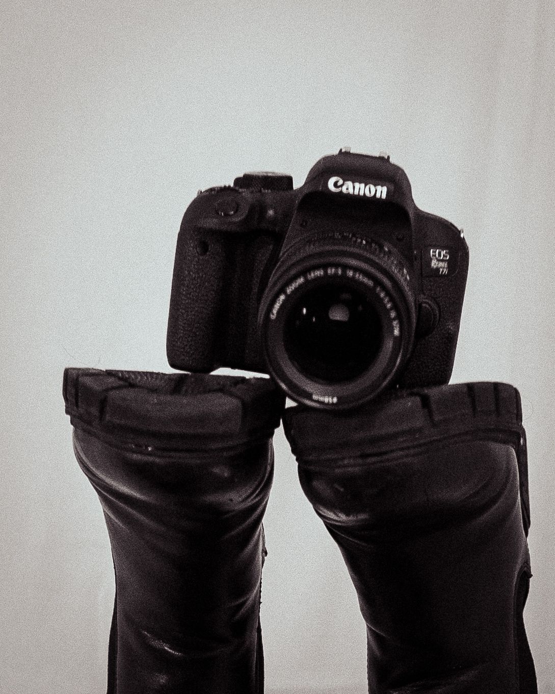 Canon camera on boots. Studio still life photo. Central MA