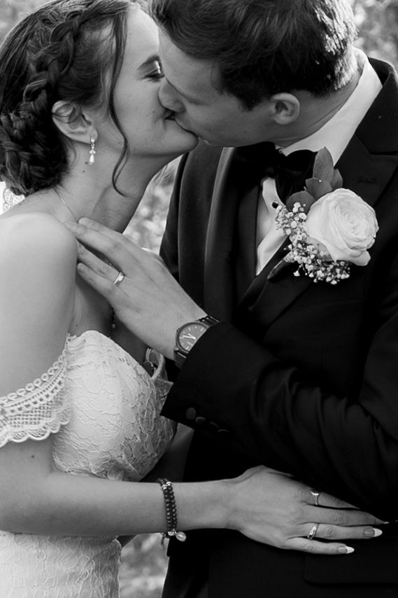 Black and White bride and groom kissing.