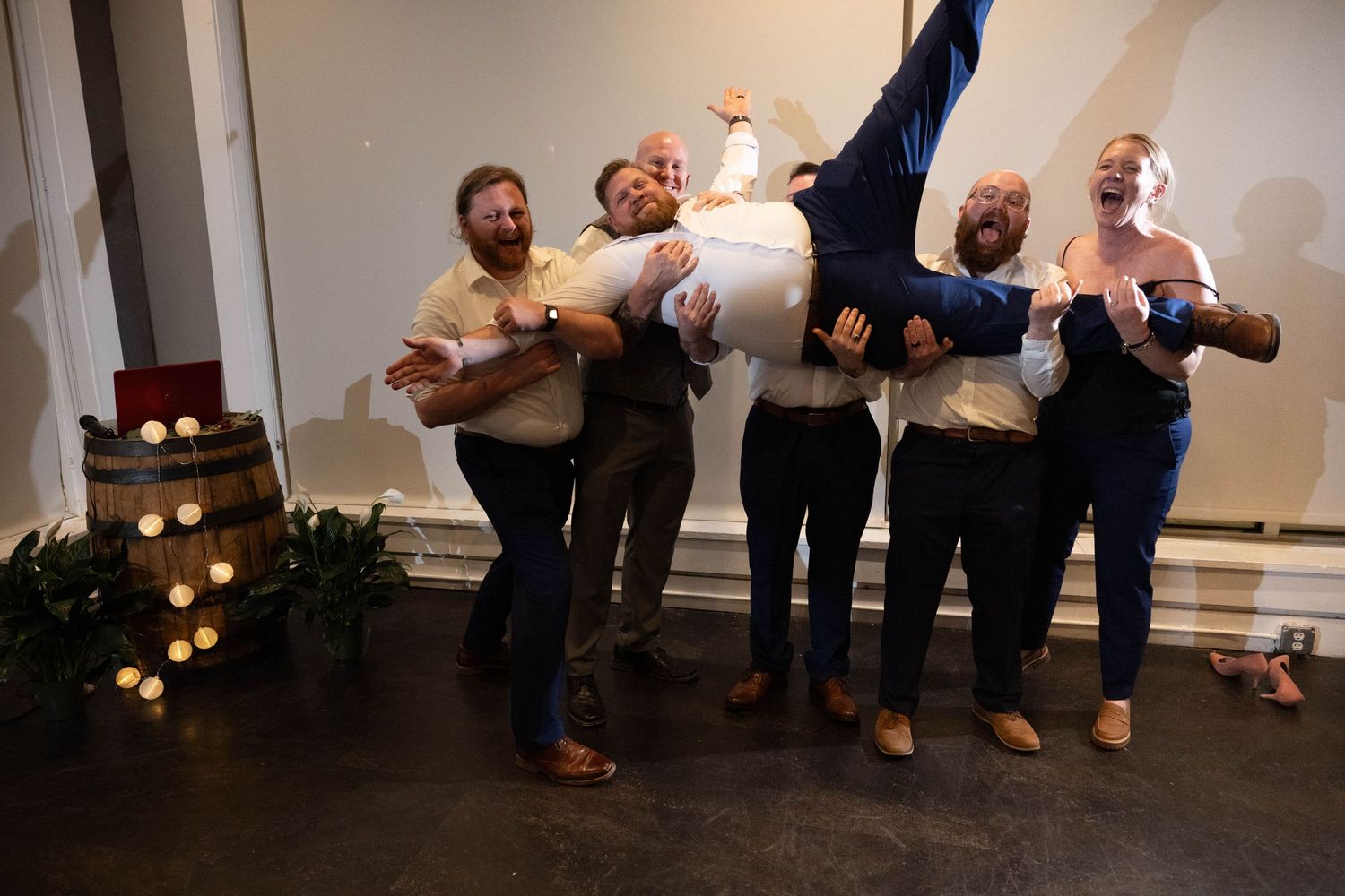 Groom being hoisted by groomsmen during reception at Three Notch'd Brewery Richmond Virginia
