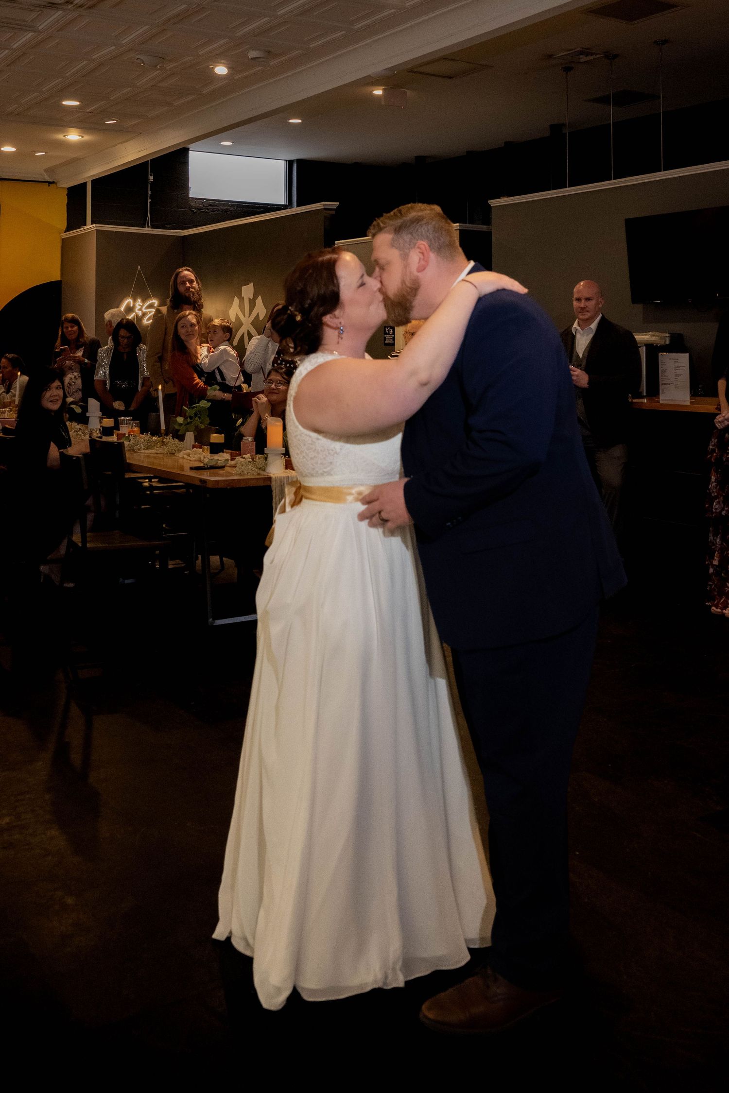 Bride and Groom kiss after first dance reception at Three Notch'ed Brewery in Richmond Virginia