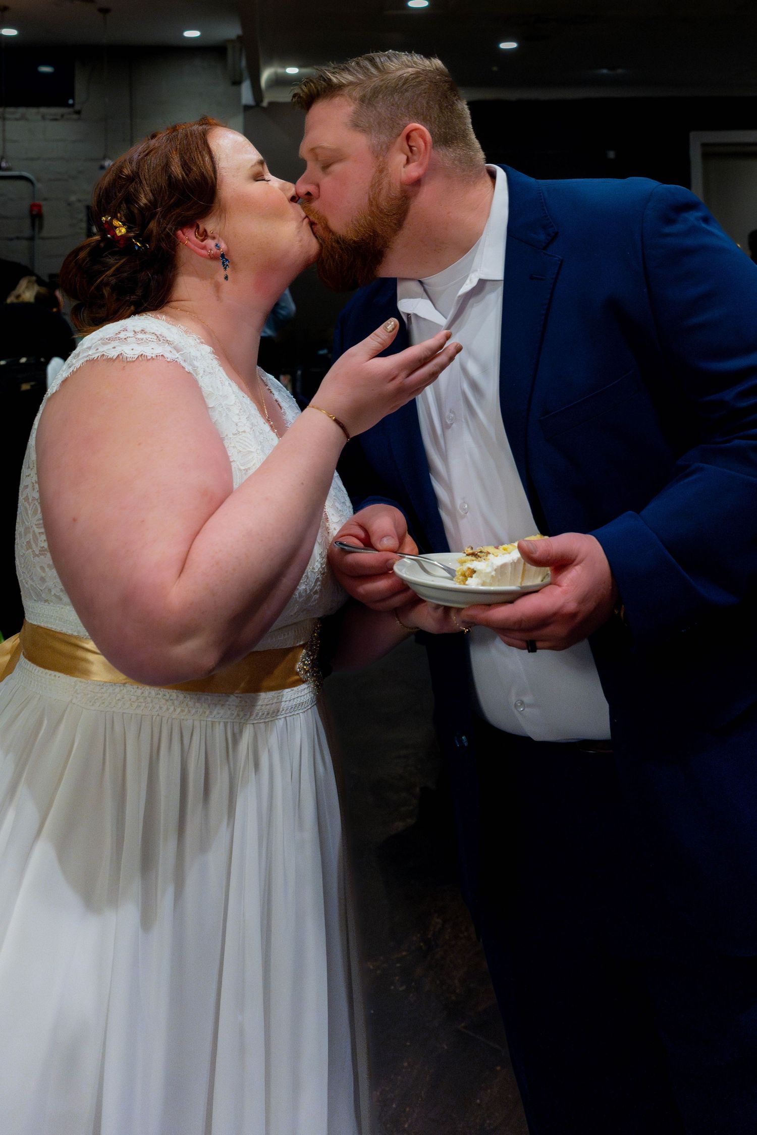 Bride and Groom Kiss after cutting the cake