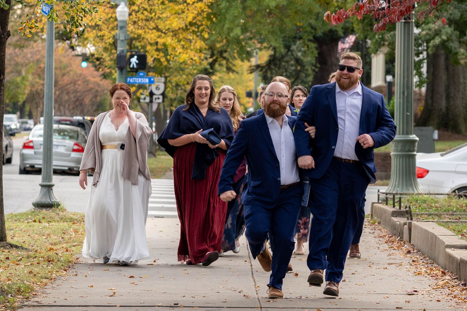 Bridal party walking to the reception Richmond Virginia Groom and Groomsman linked arms skipping