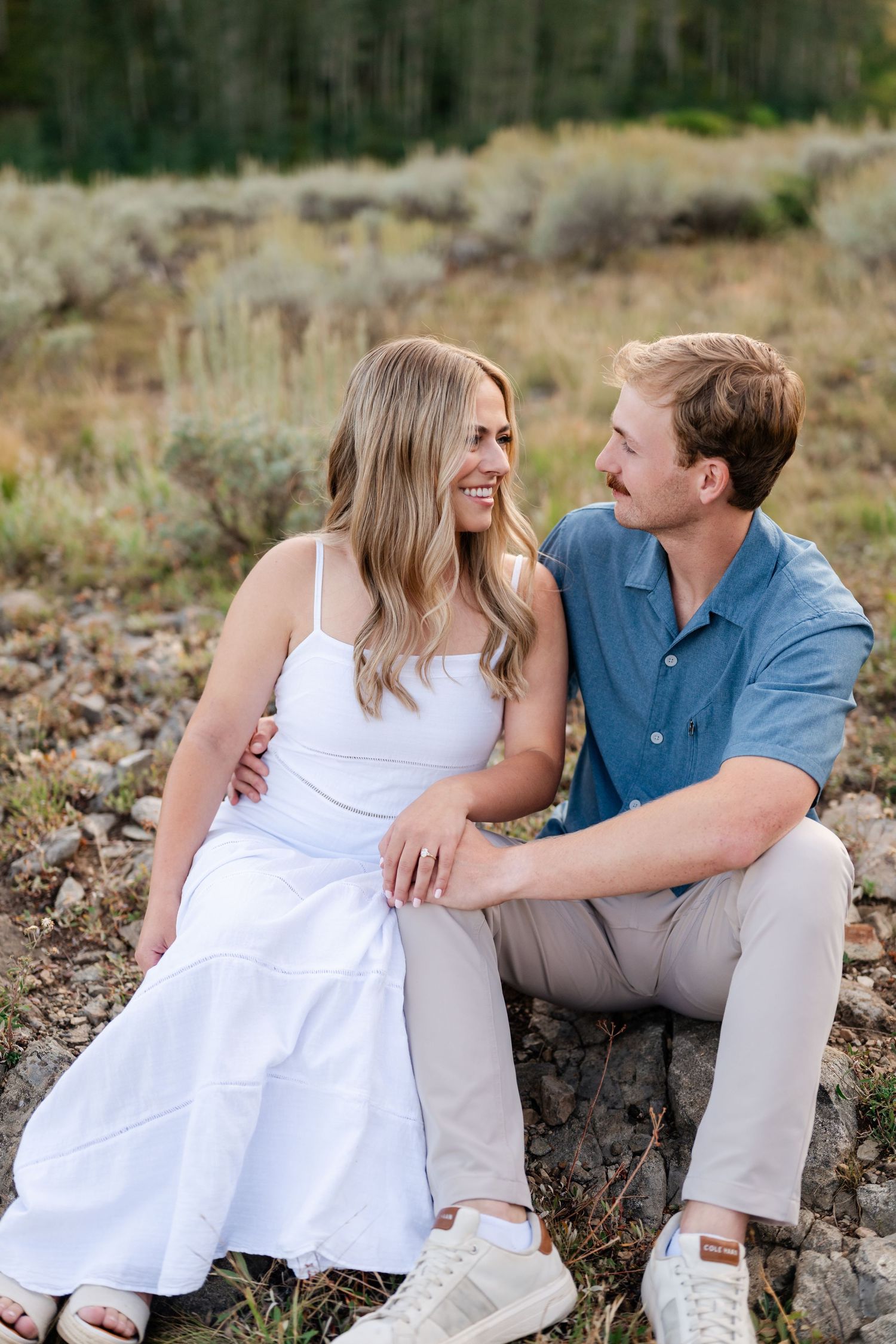 Park City mountain location inspiration for a surprise proposal. Happy couple laughing to each other at Guardsman Pass.