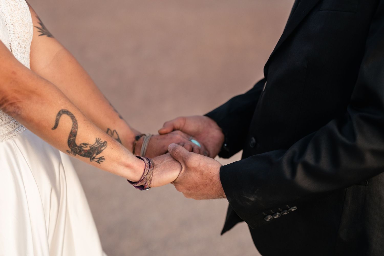 Elopement couple hold hands in Arches National Park by Utah Elopement Photographer and videographer