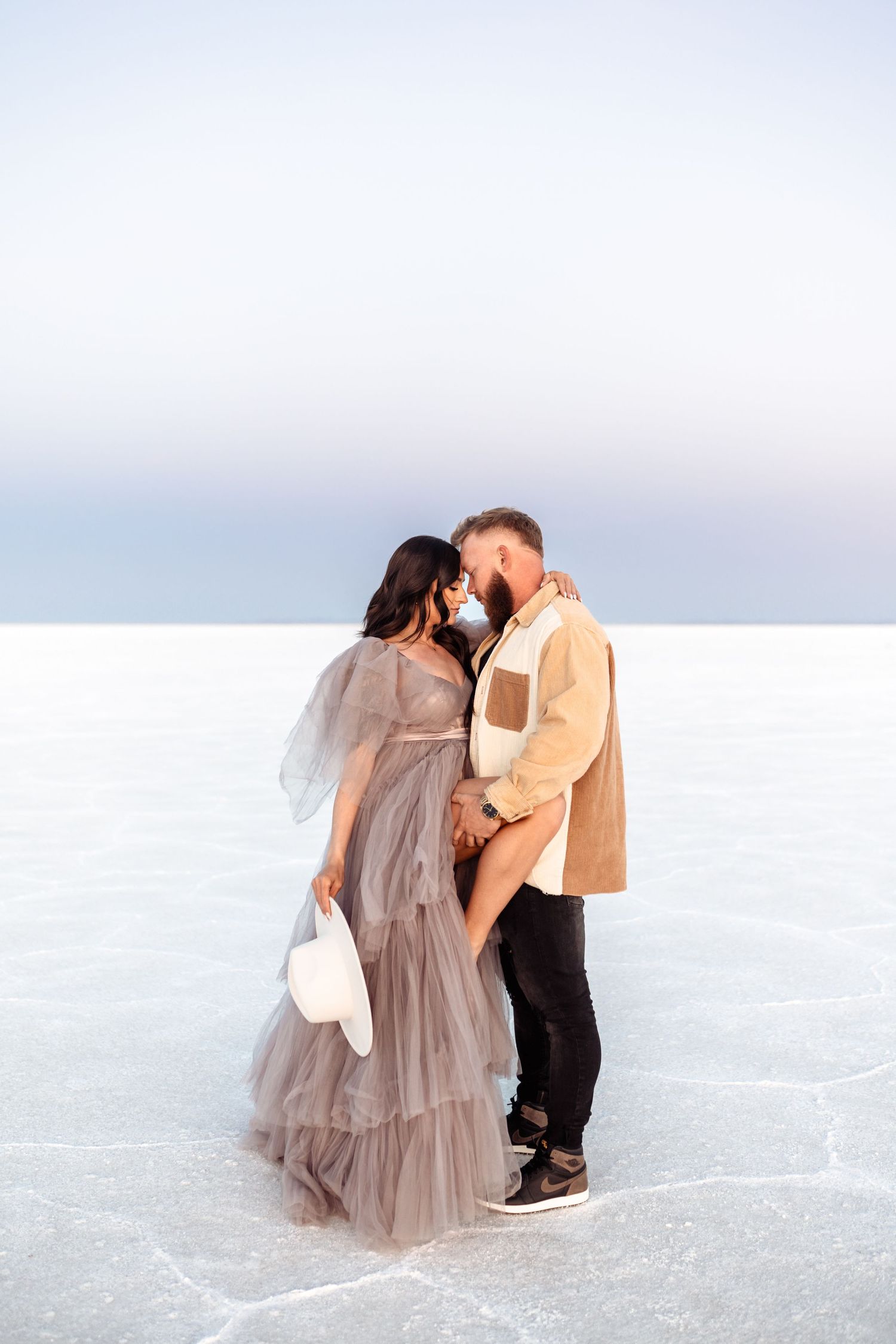 Salt Flats photos of a couple during sunset by Utah engagements photographer