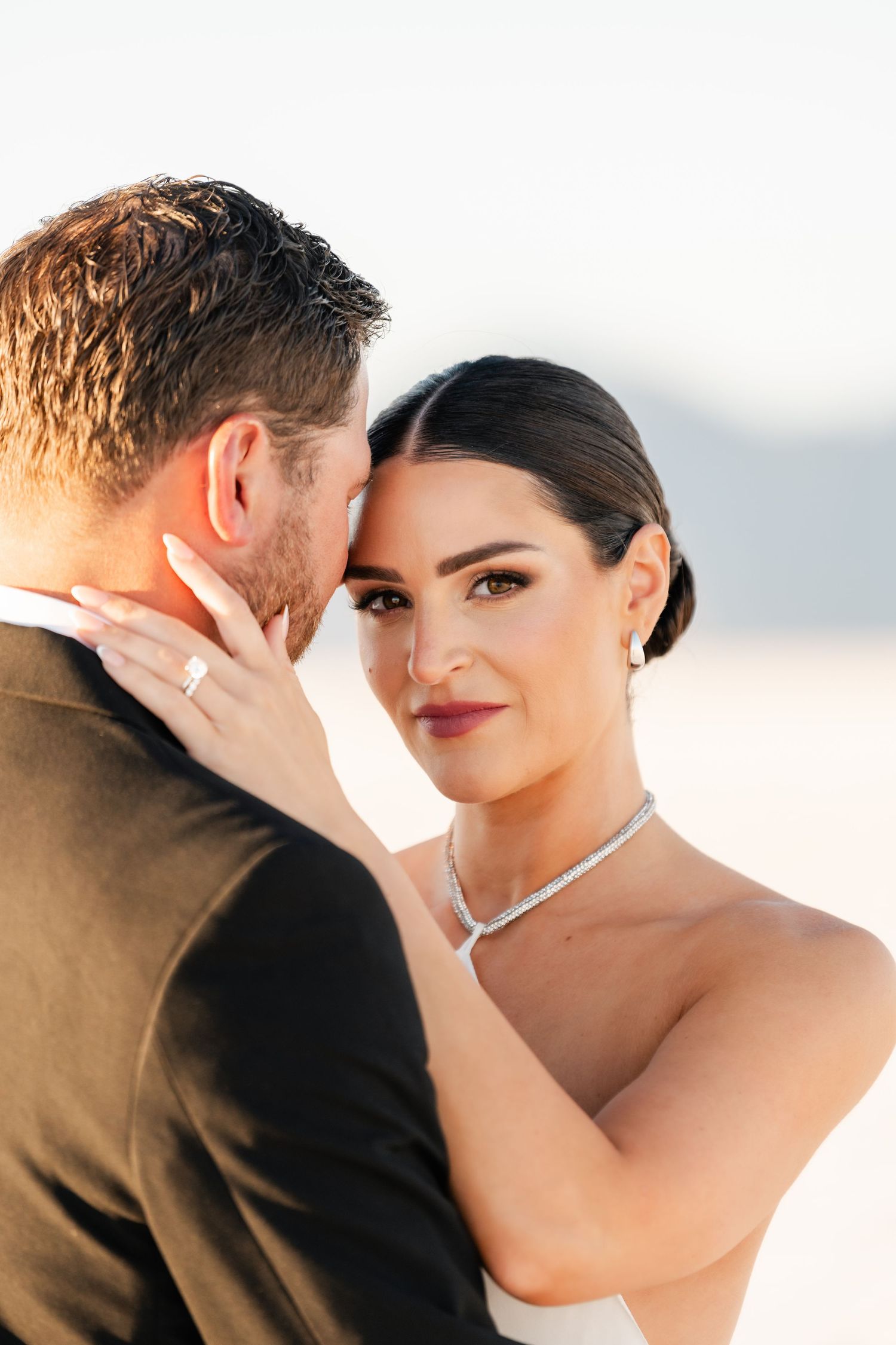 Salt Flats Photographer. A romantic close-up moment between a couple during their wedding photoshoot with soft golden lighting.
