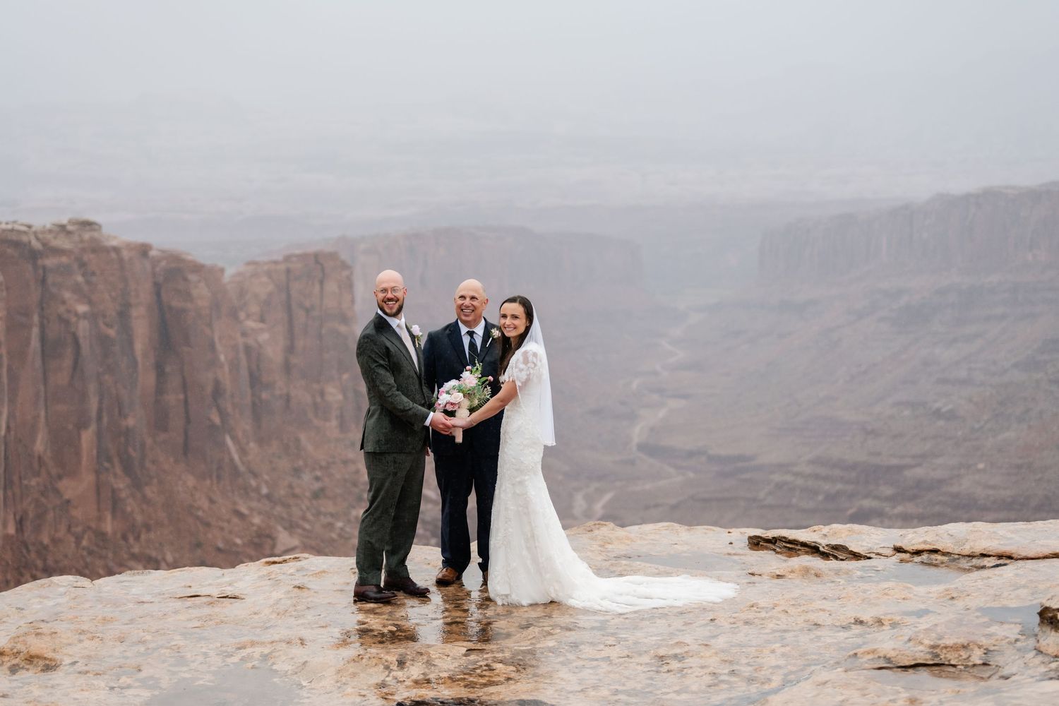 Wedding ceremony moments captured against a dramatic desert canyon backdrop.