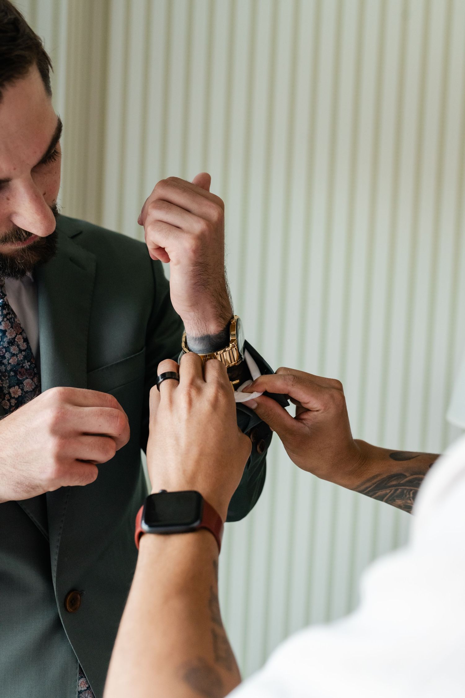 Close-up shots showing hands adjusting a watch or bracelet on someone's wrist.