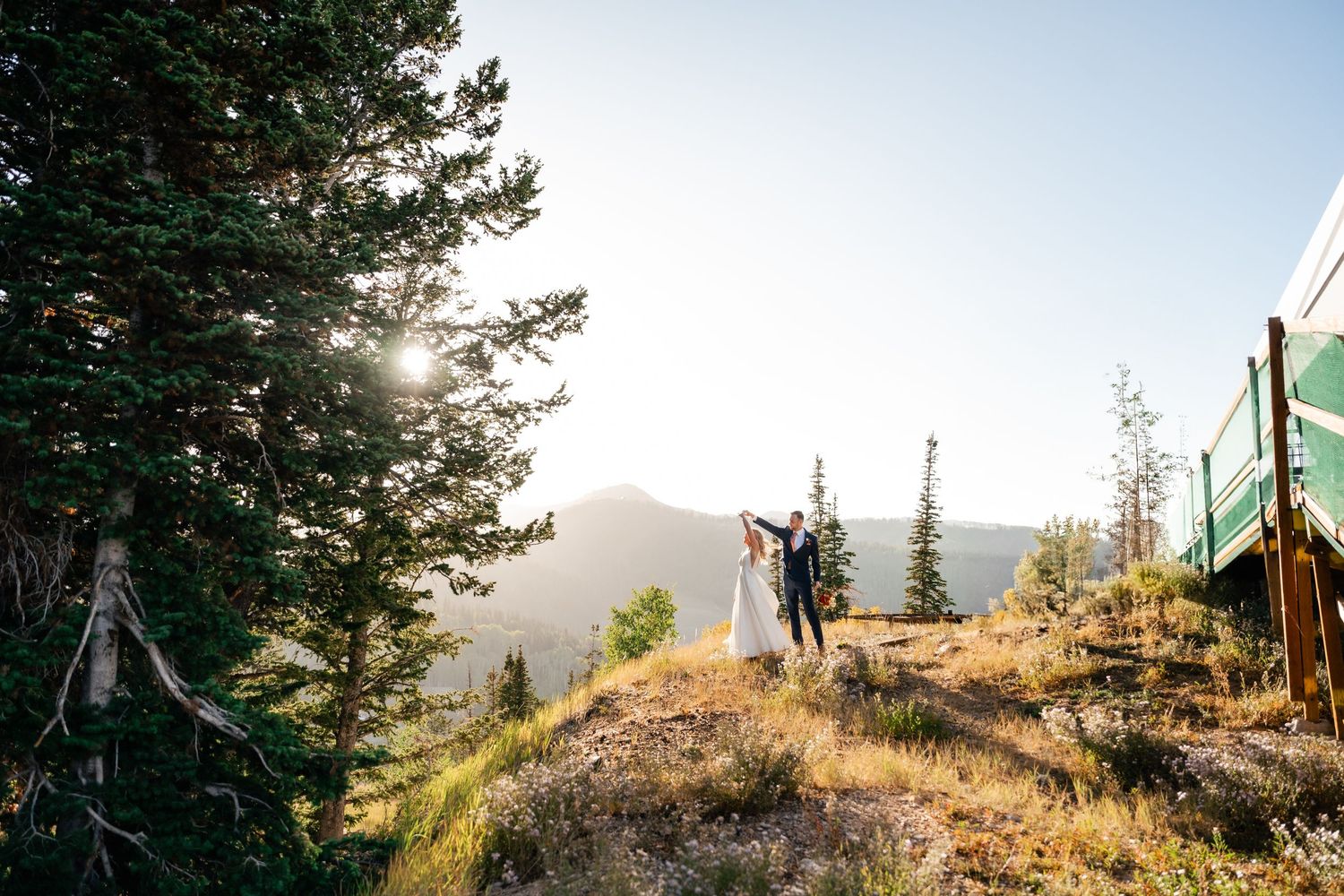 Scenic mountain landscape view with ski lift equipment in golden afternoon light.