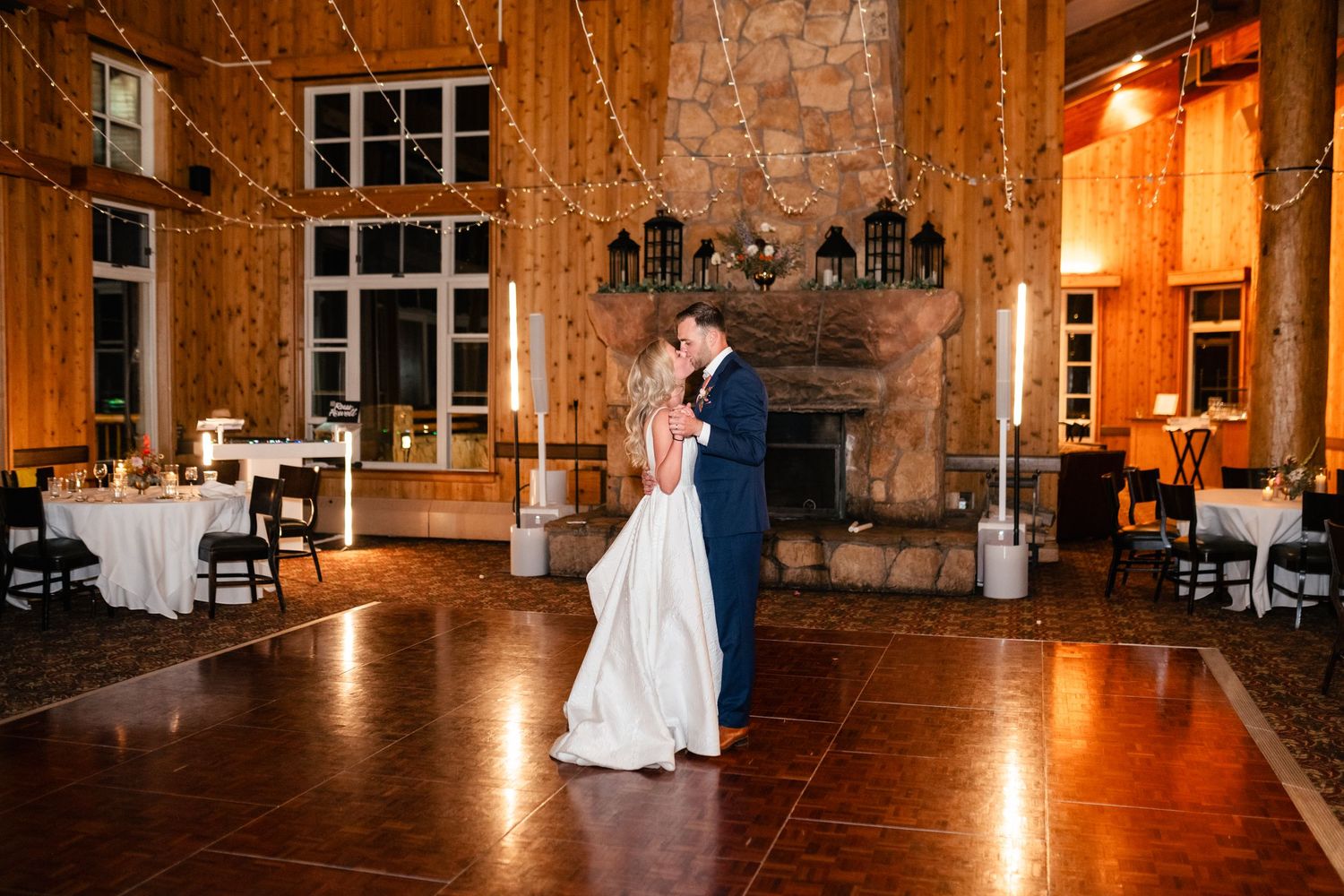 Elegant barn wedding venue featuring stone walls, wooden beams, and romantic lighting for the reception.