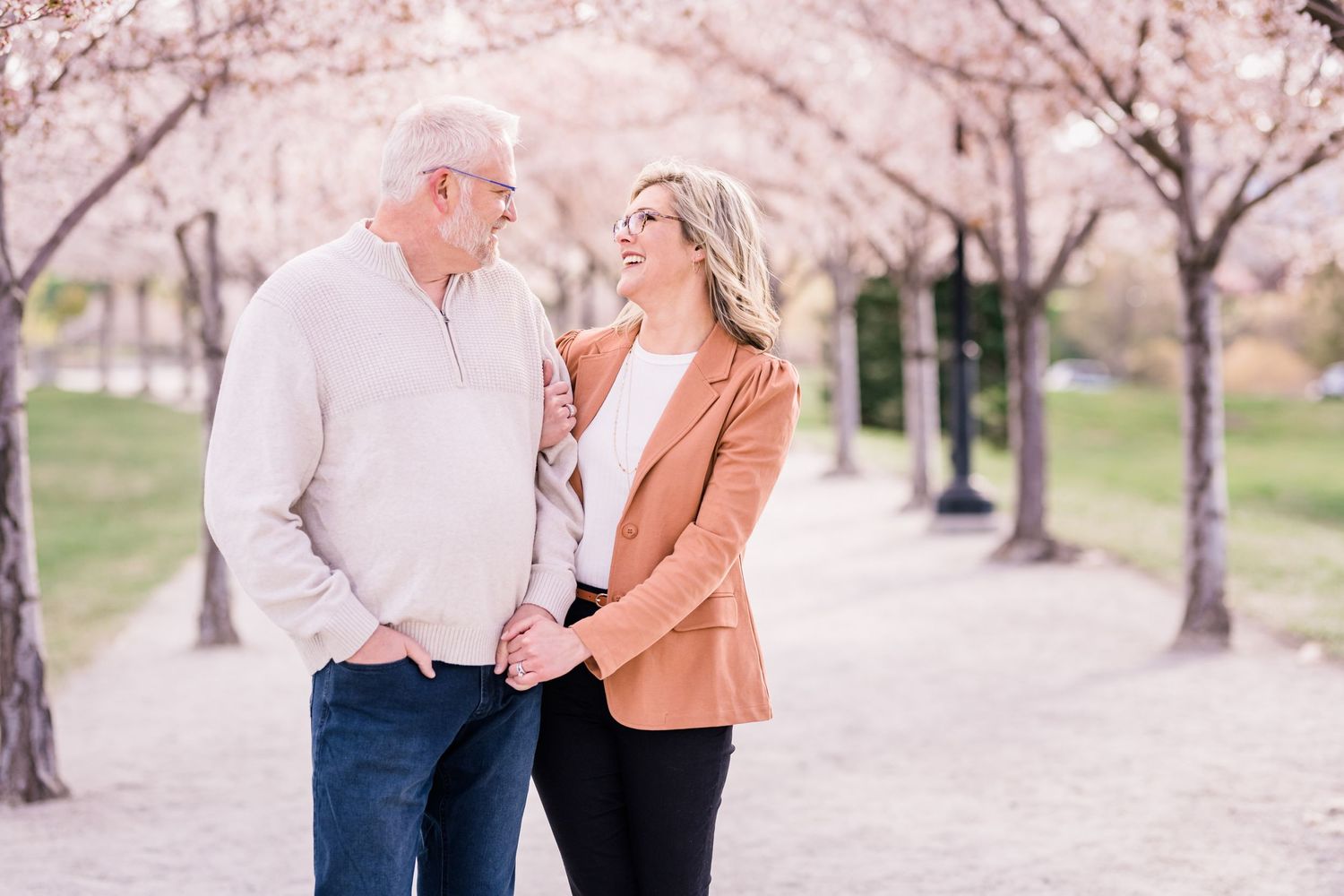 Couple holding hands at the Capitol blossoms by Utah engagement photographer Coley Cook