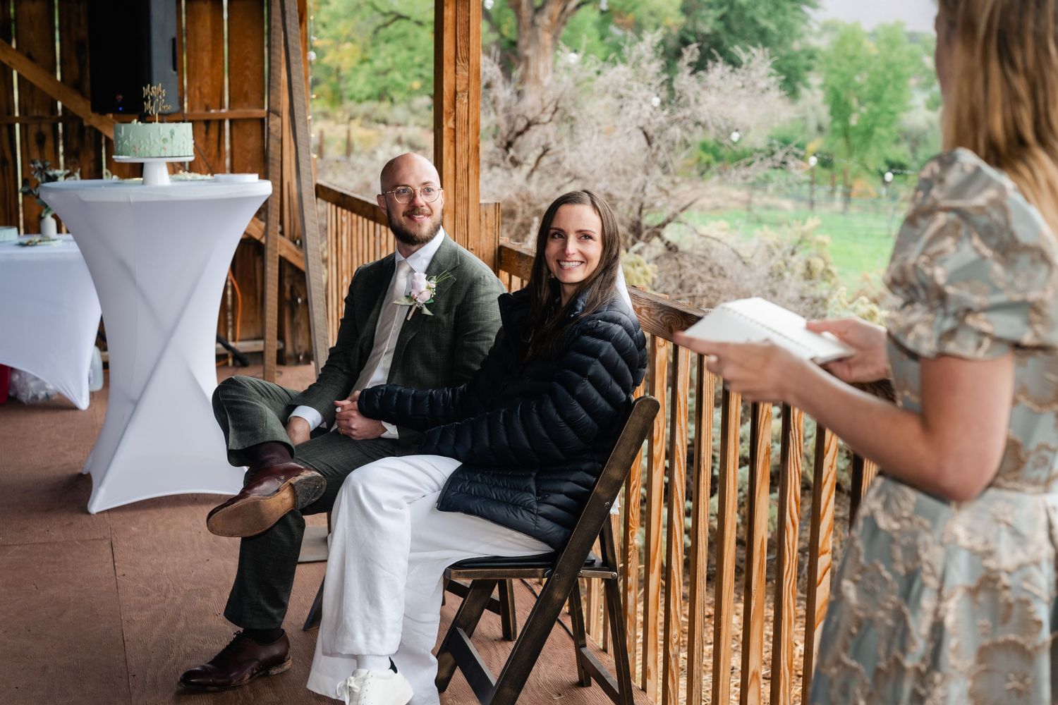 Wedding guests interacting at cocktail tables during an outdoor reception.