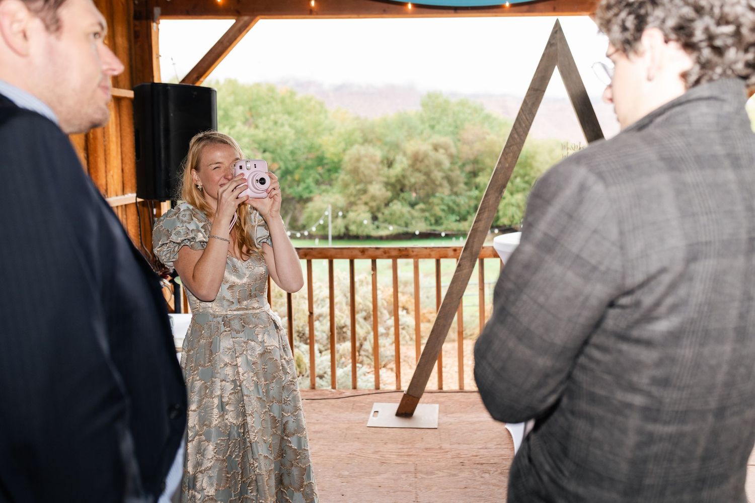 Guests mingling on covered outdoor patio during special event.