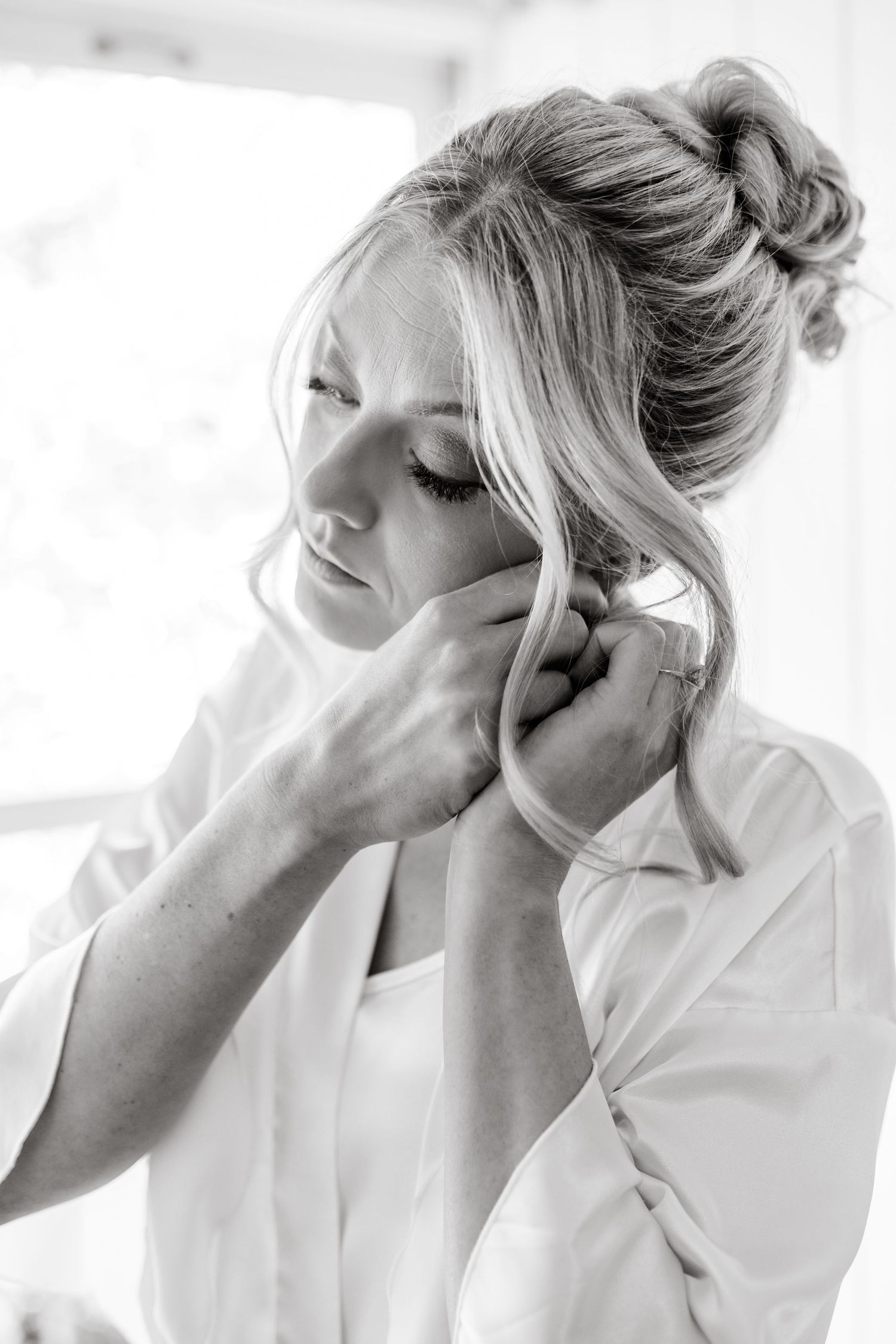 Series of black and white photos showing preparation moments in a white robe.