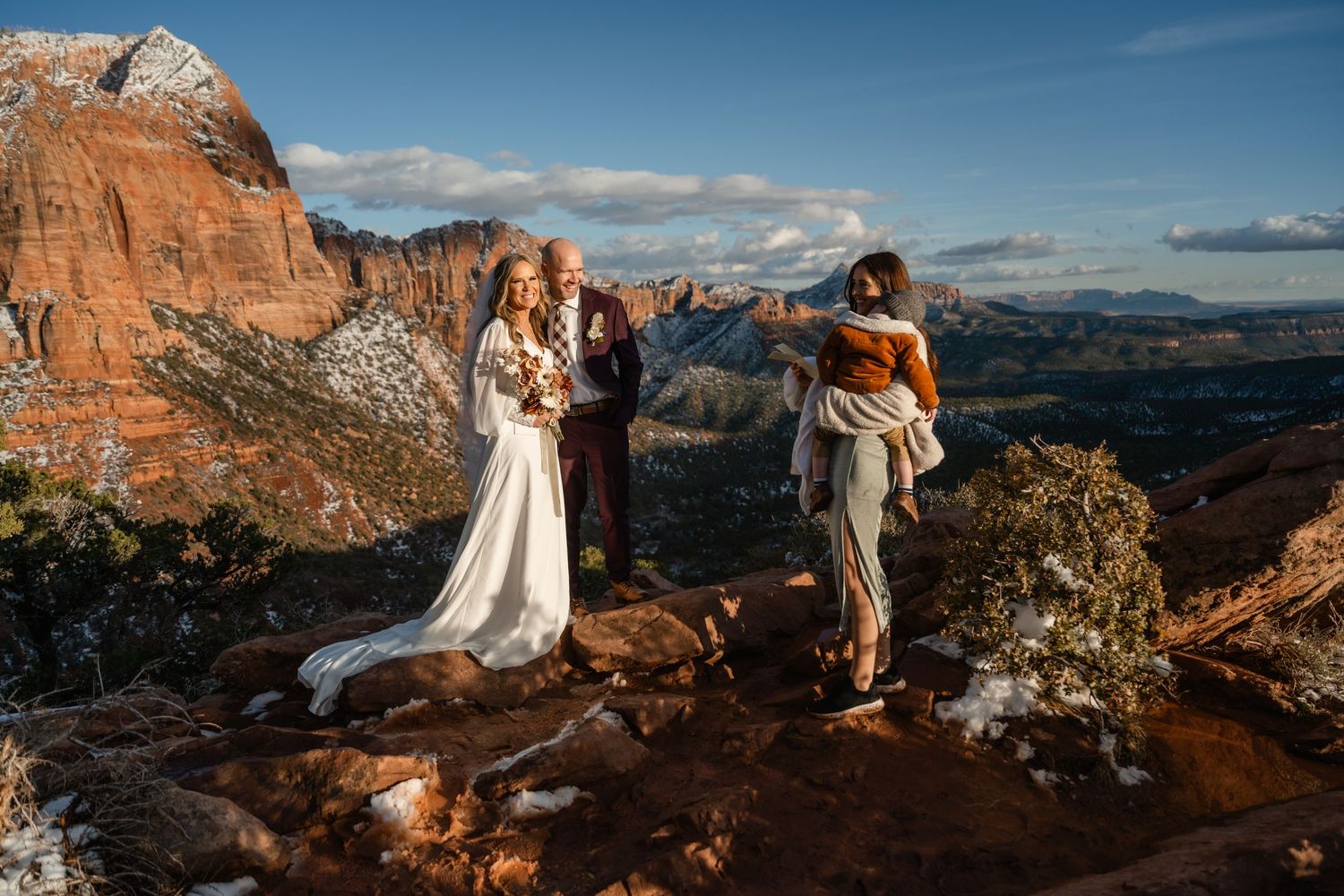 Wedding celebration overlooking vast canyon landscapes with dramatic red rock formations.