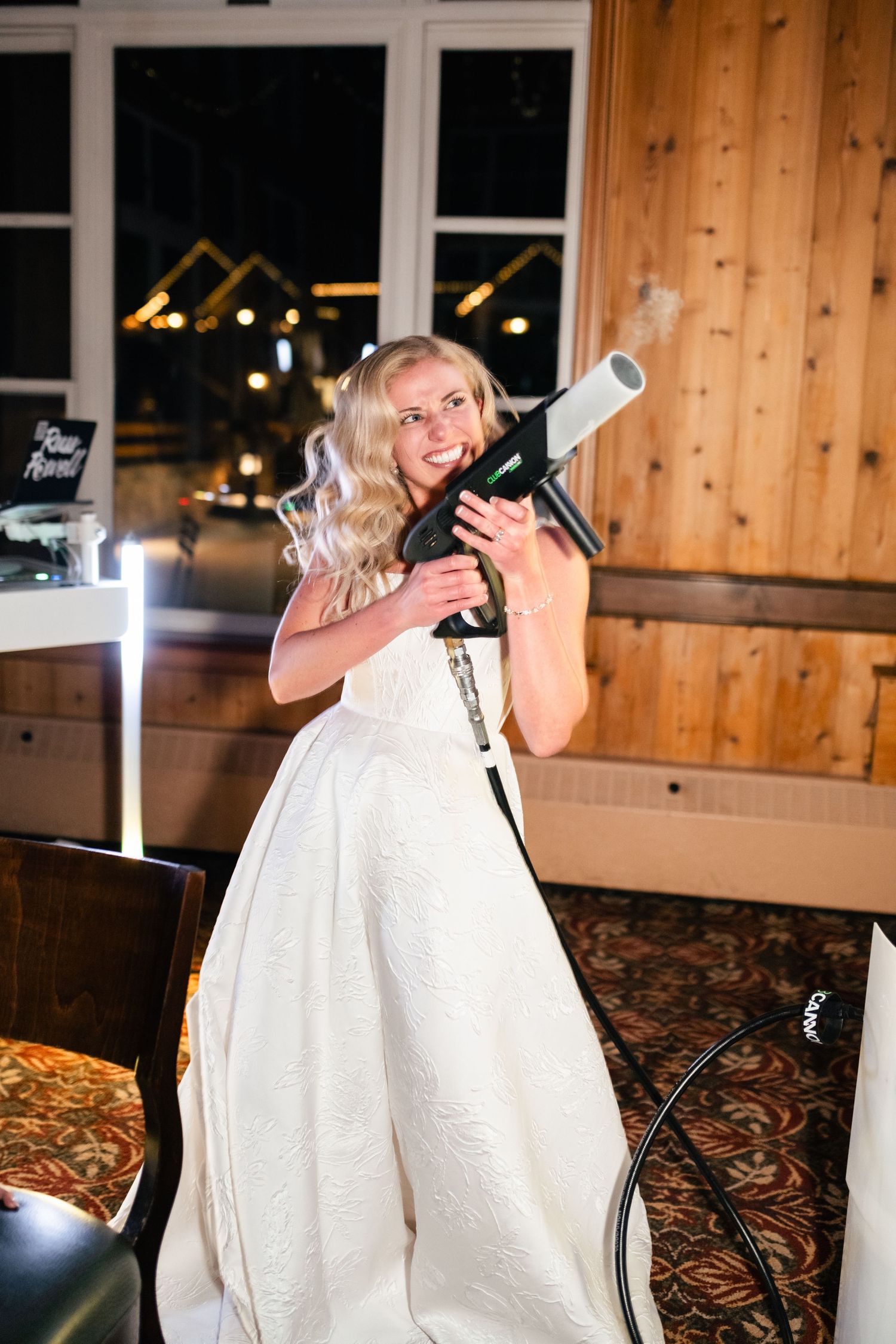 Wedding celebration in rustic venue with wood paneled walls and festive atmosphere.