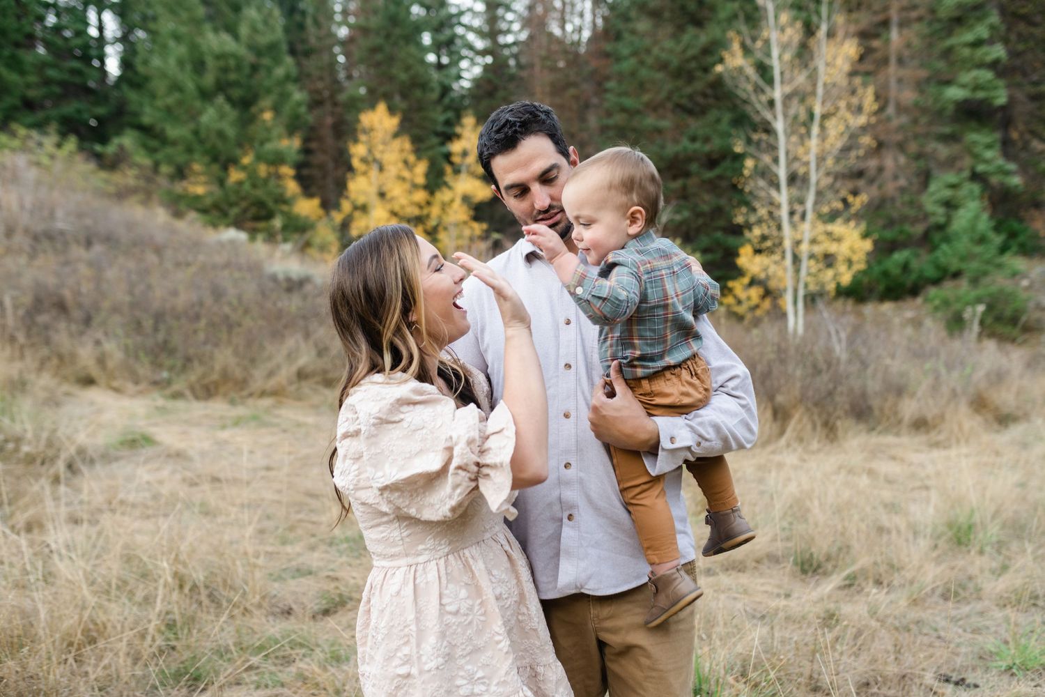young family has a close cuddle together in American Fork Canyon for their fall family photos