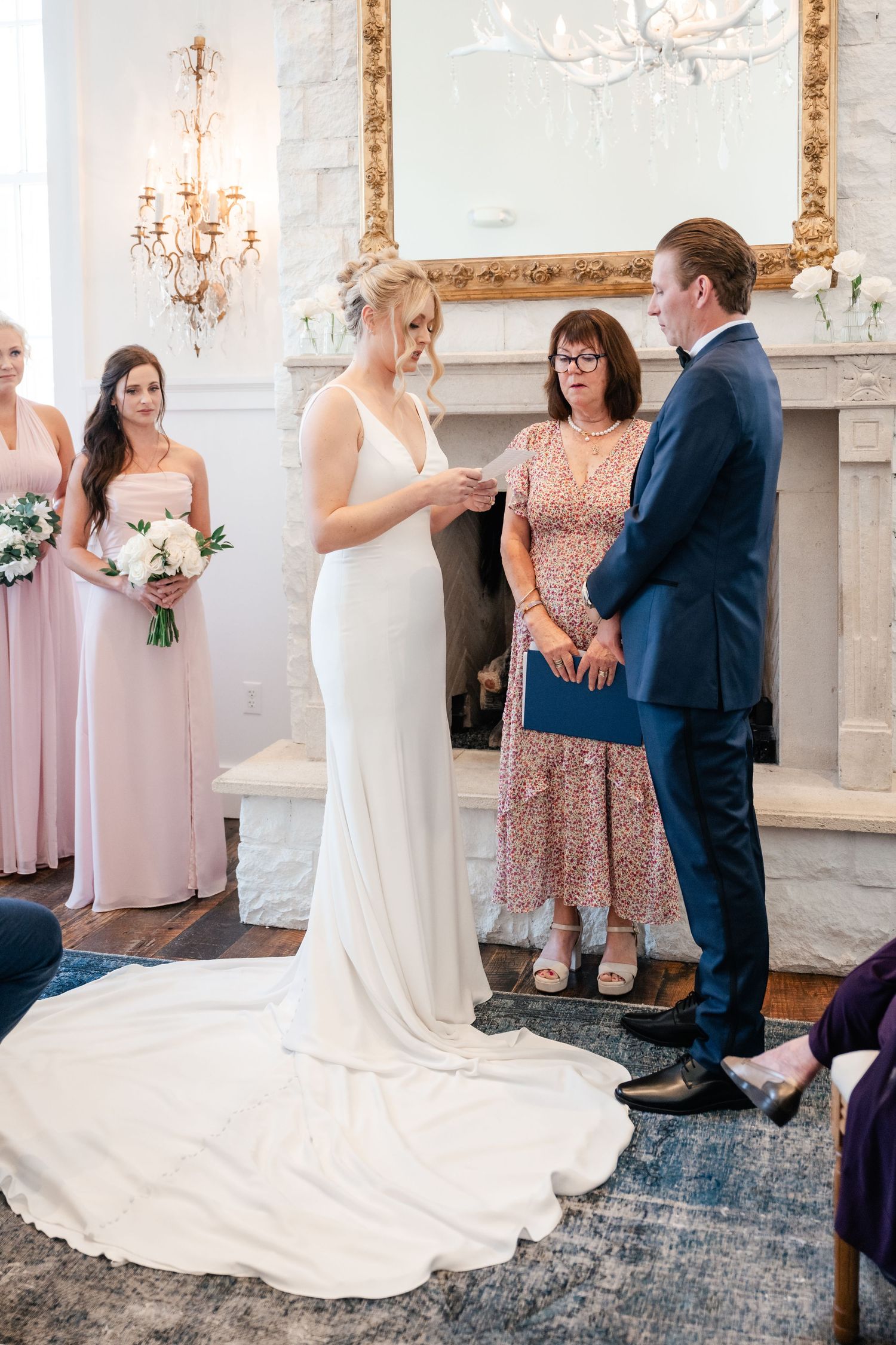 Wedding ceremony moments captured in elegant white room with vintage decor.