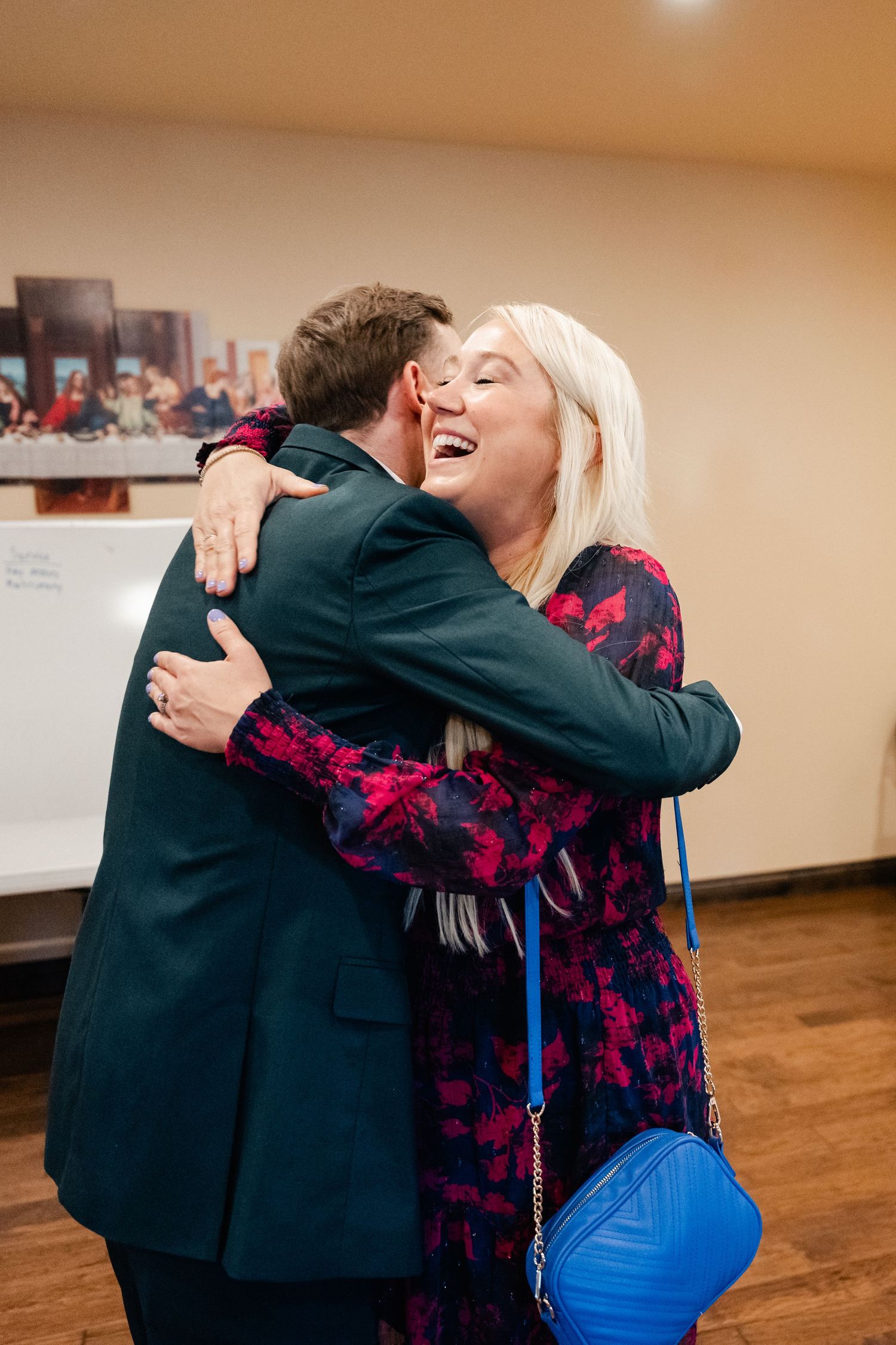 Emotional embraces shared between wedding attendees in formal attire.