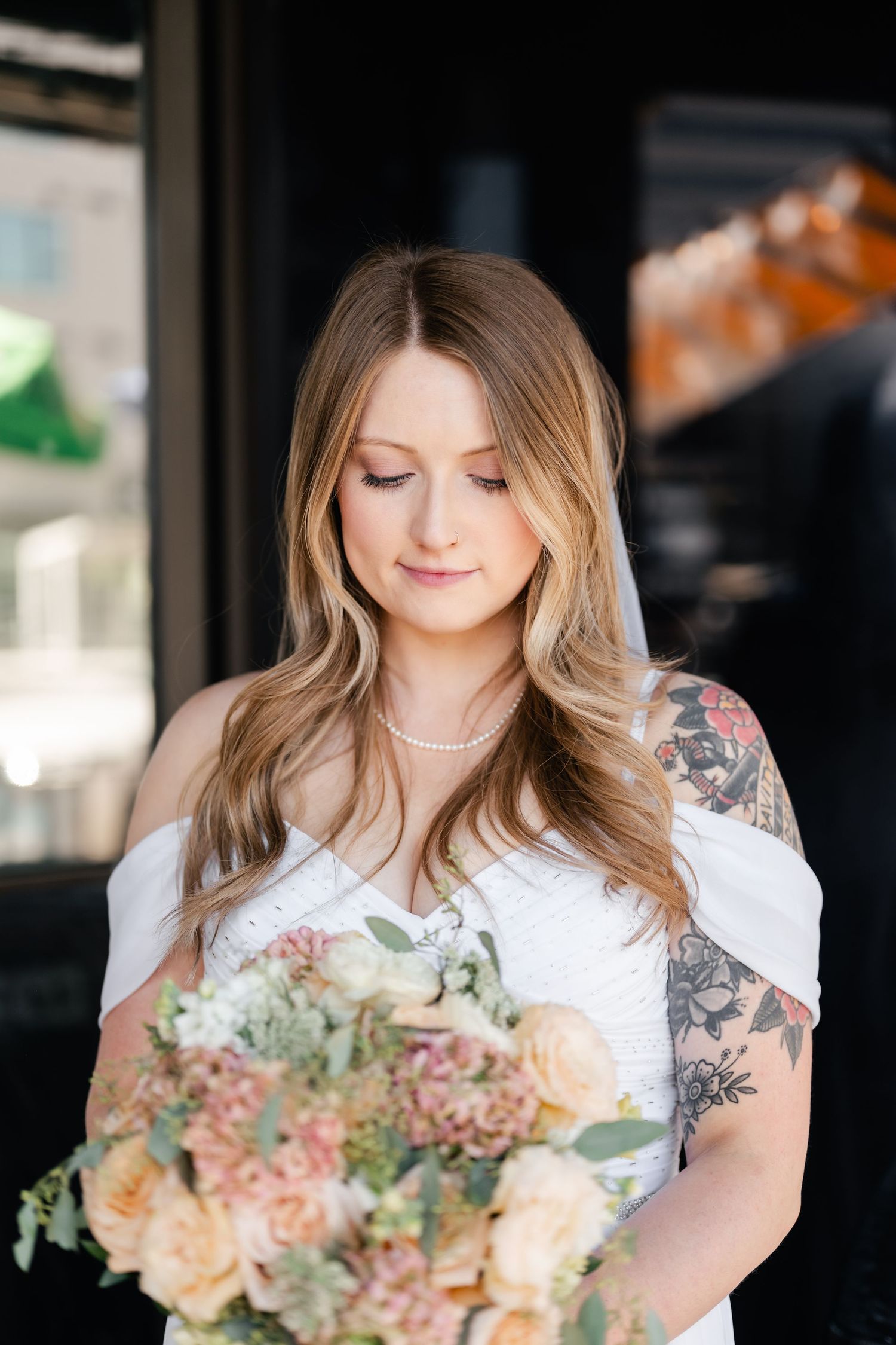 A series of close-up shots showing someone holding a bouquet of peach and blush flowers with wavy hair.