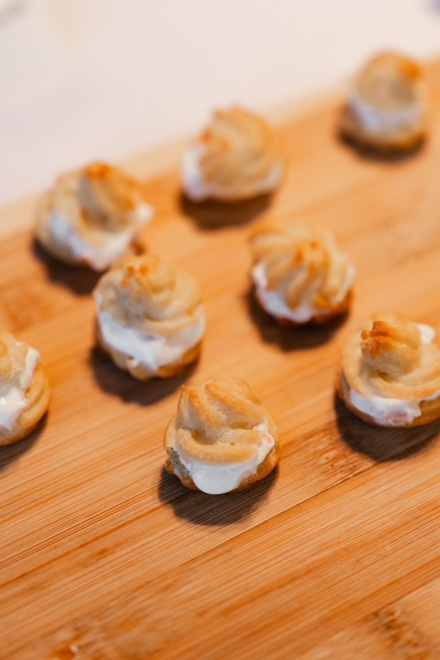 Close-up of chocolate dessert bites arranged on a wooden bamboo surface.