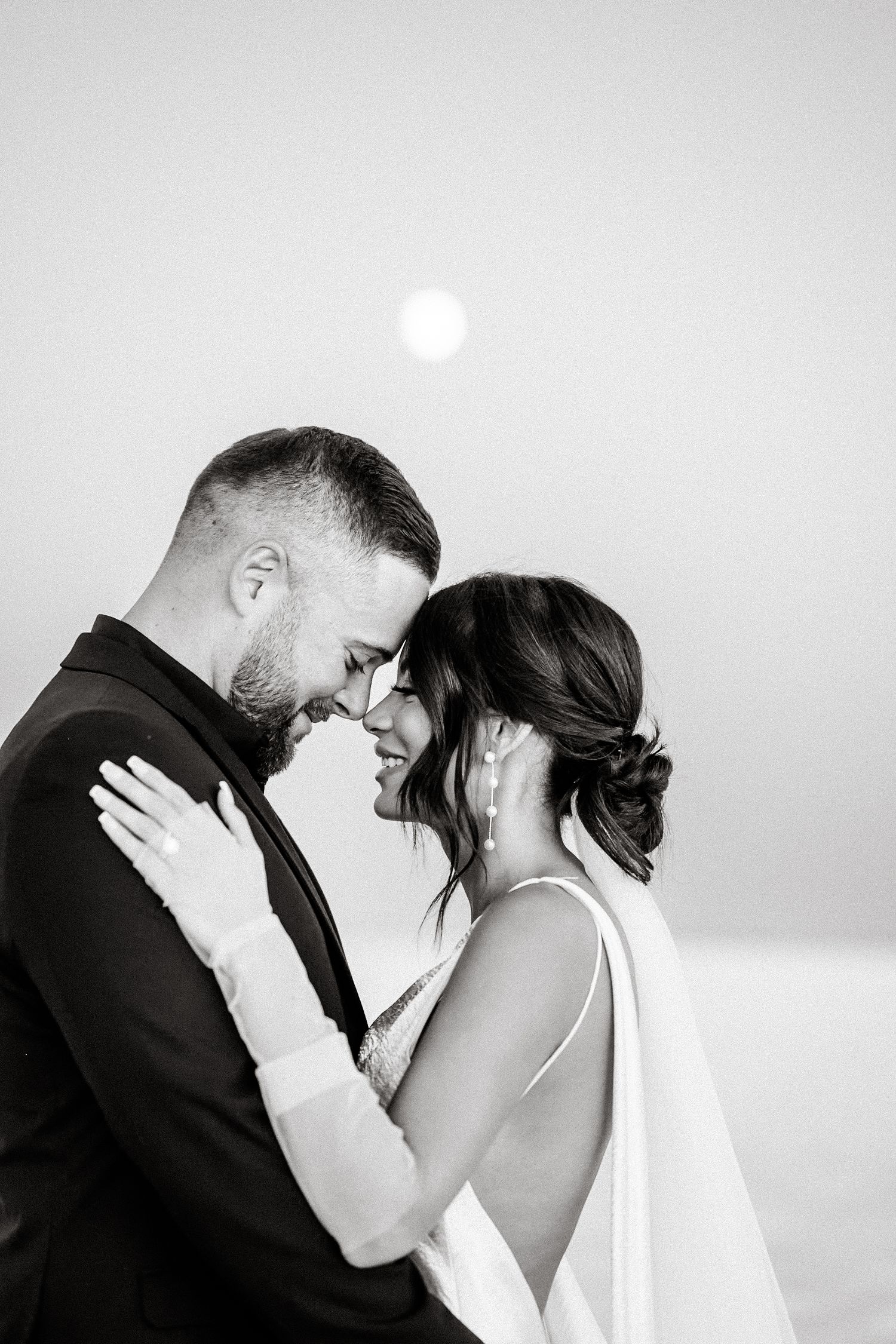 Intimate black and white wedding portraits showing tender moments between newlyweds.