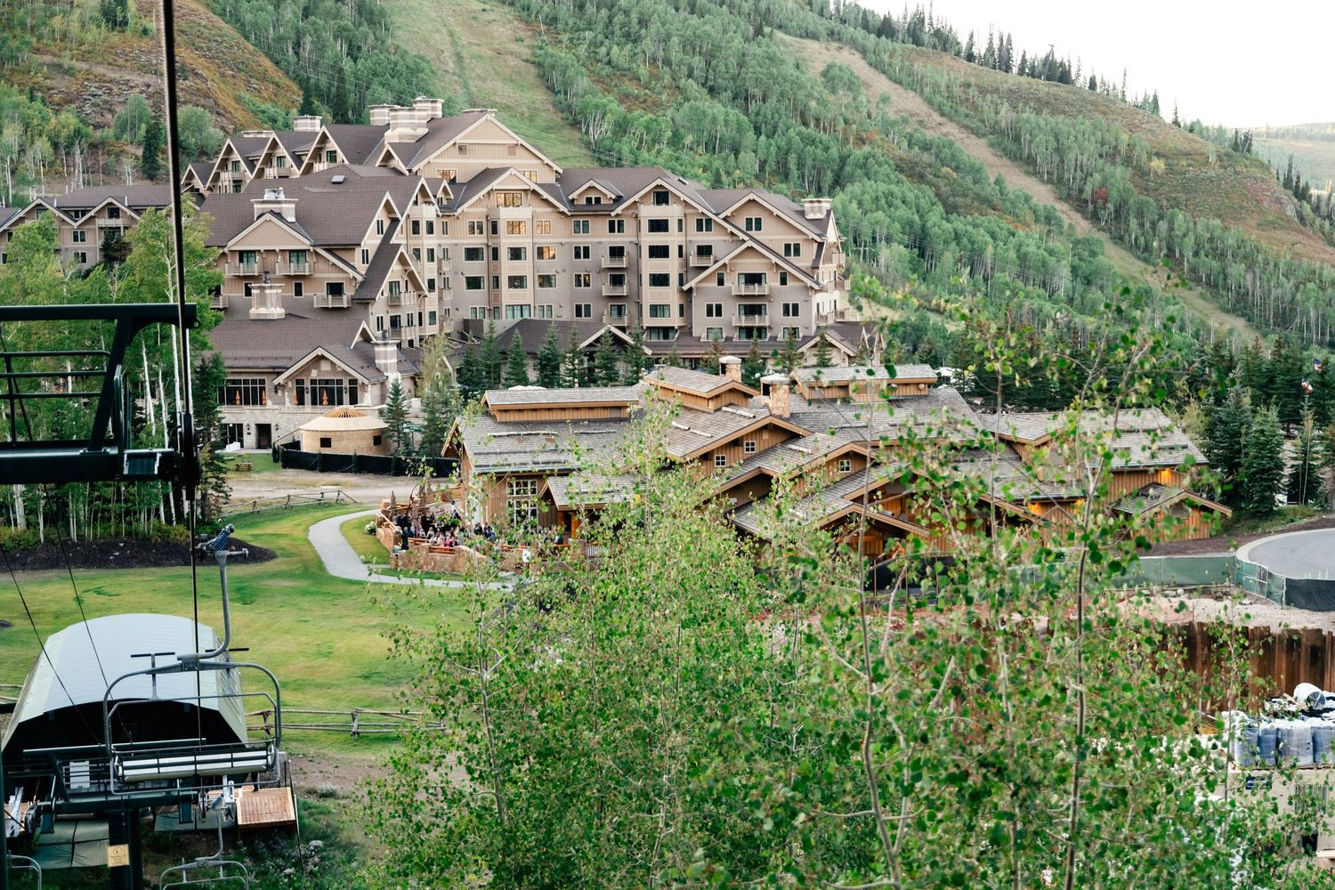 Scenic mountain resort village nestled among green slopes and trees.