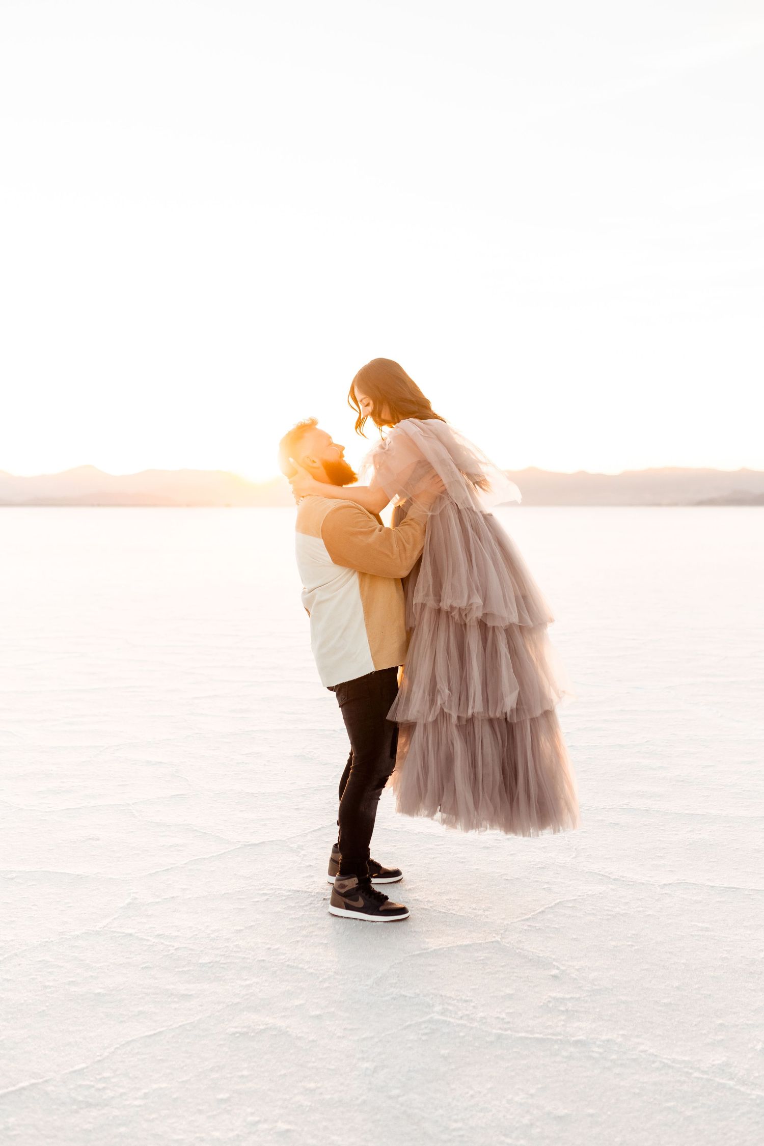 Couple dances on the Salt Flats during their photoshoot by Utah Wedding Photographer