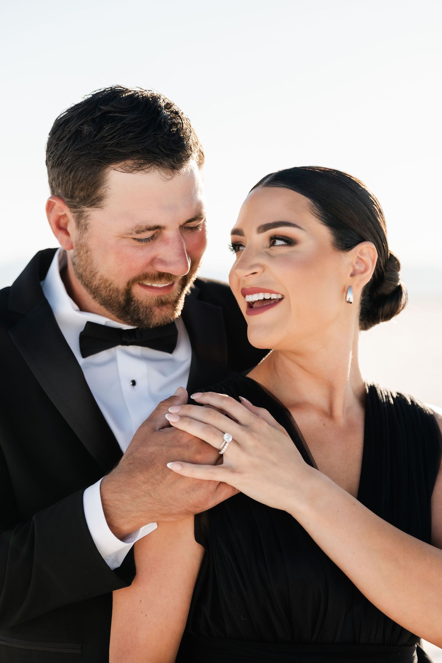 A romantic series of close-up shots showing a couple in formal attire sharing intimate moments against a white backdrop. Salt Flats Photos.