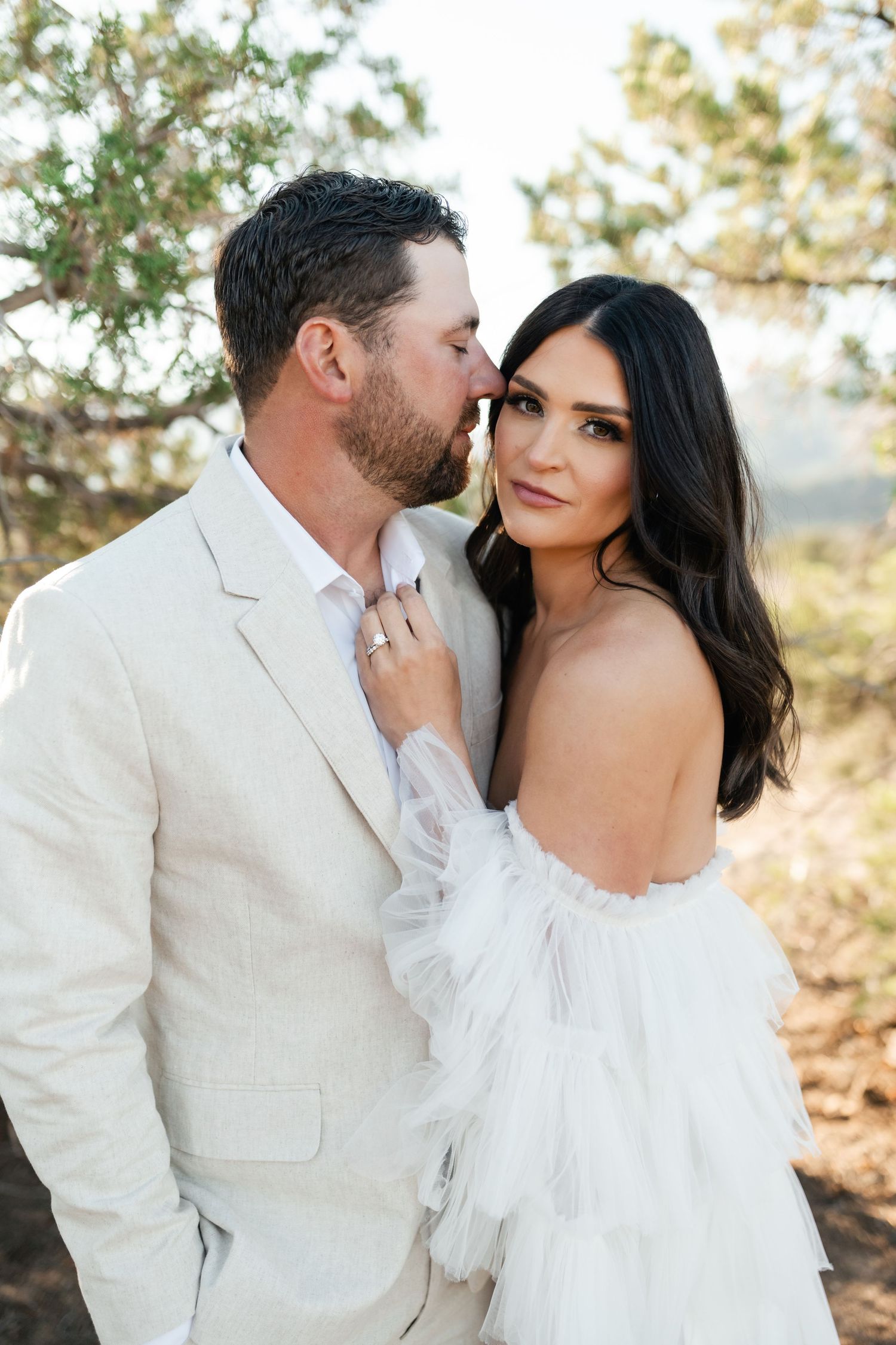 Zion destination photographer, A romantic desert photoshoot featuring a couple in white attire against natural scenery.