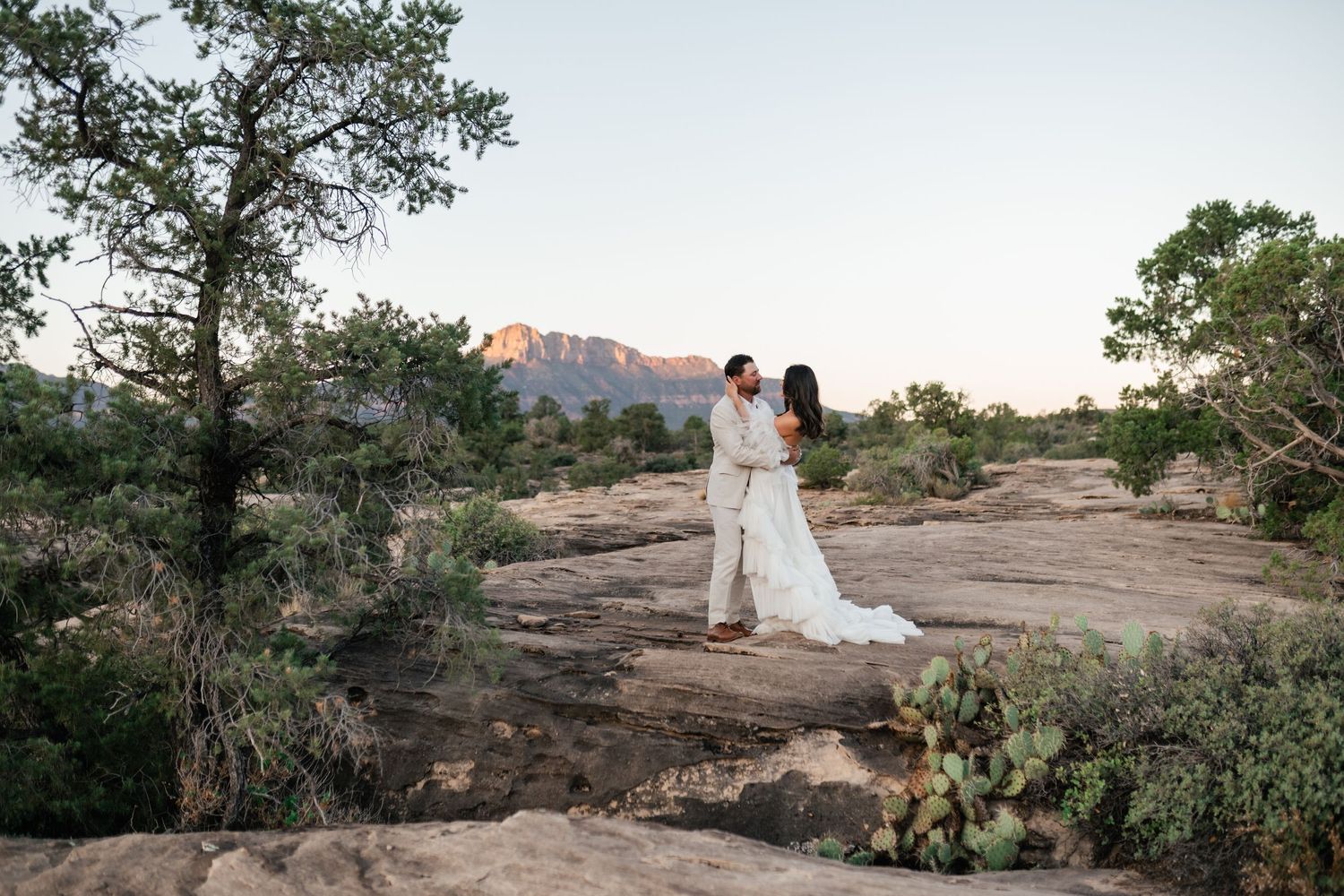 Zion Adventure Session. A panoramic view of red rock formations and desert landscape during golden hour.