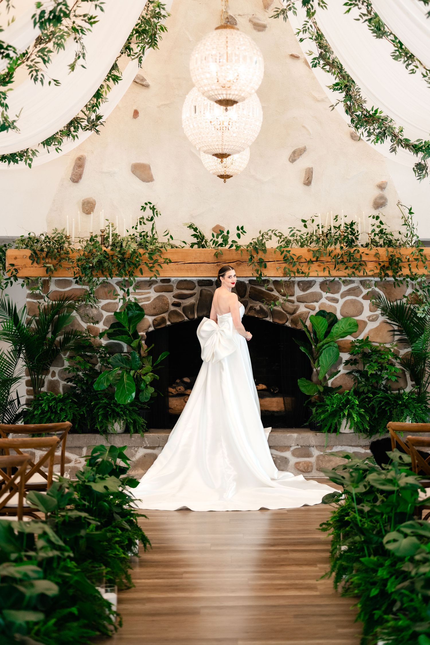A bride in a flowing white wedding gown stands elegantly at Northridge Valley Event Venue by preferred vendor Coley Cook Photography.