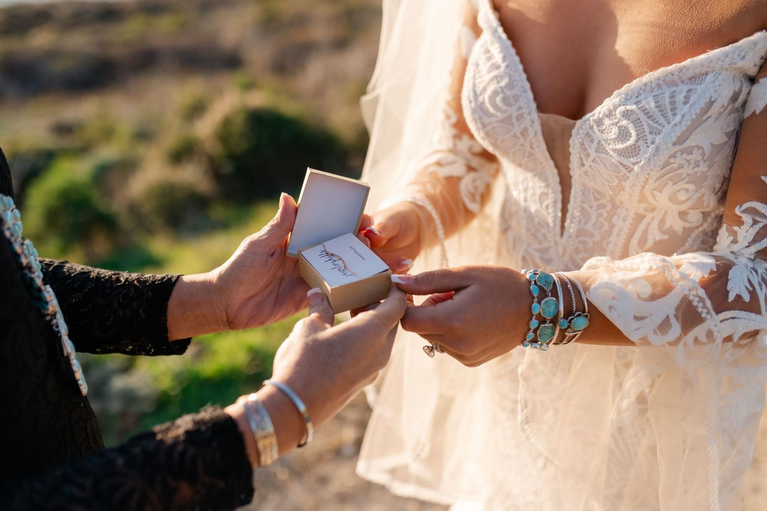 Close-up of hands exchanging wedding vows written on paper.