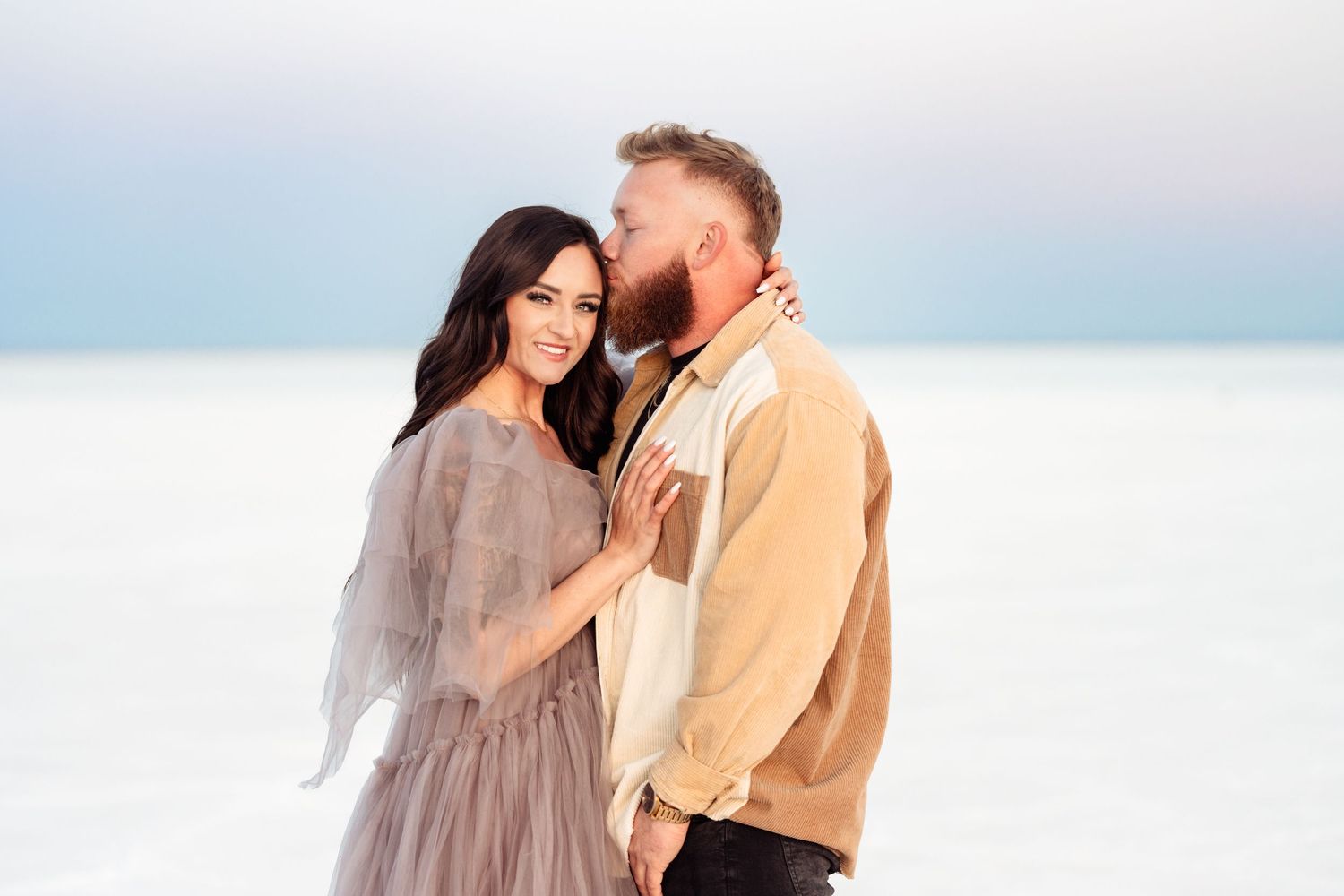 Utah Salt Flats Photographer. Intimate portrait of couple embracing on salt flats during sunset photoshoot.