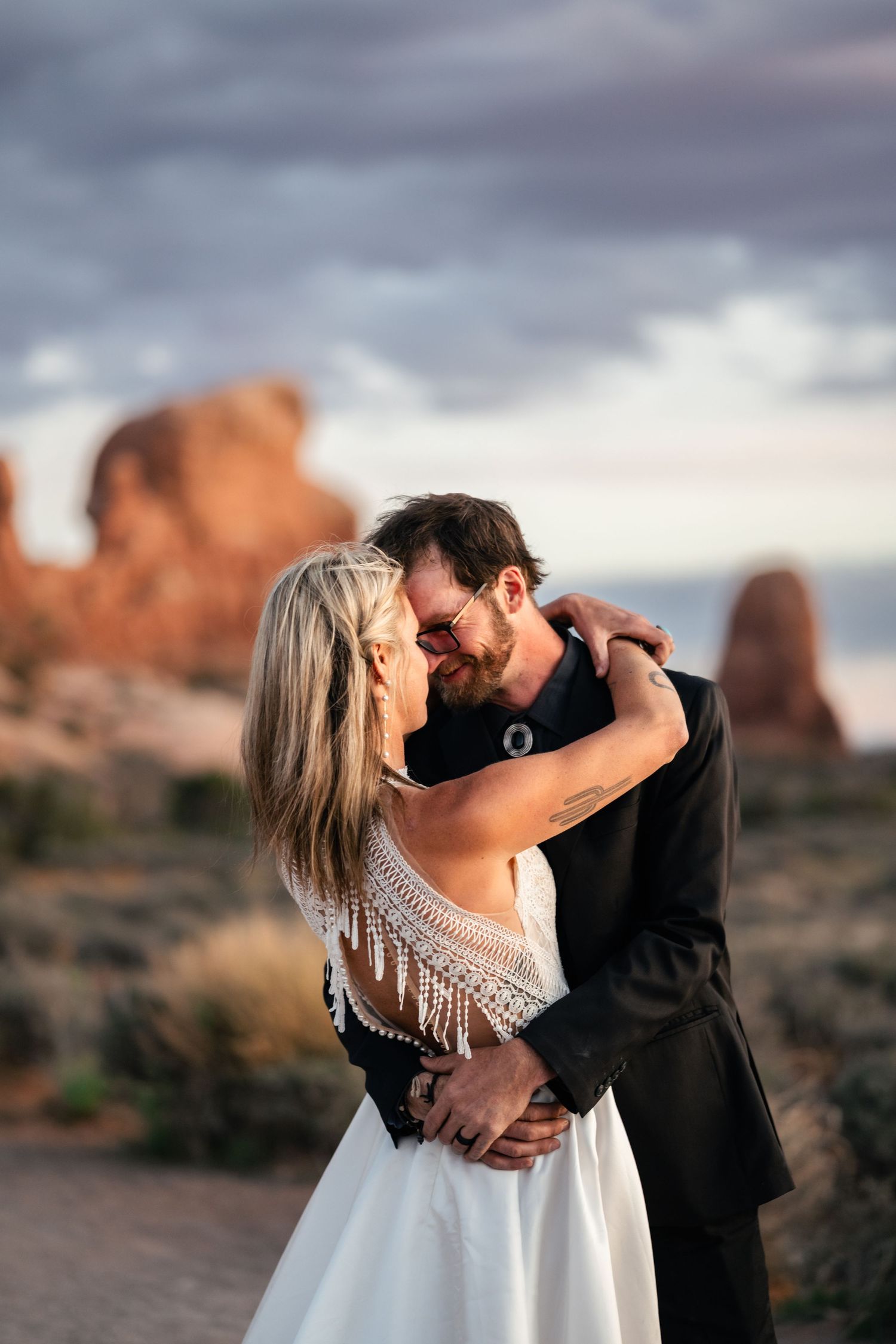 elopement couple close snuggle at Arches National Park by Utah Elopement Photographer