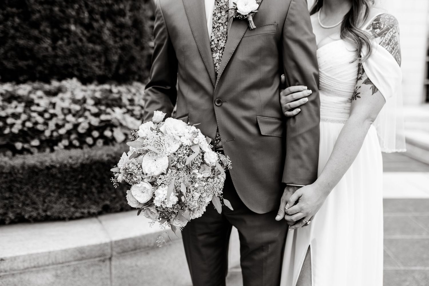 Black and white wedding photo series showing romantic moments between bride and groom outdoors.