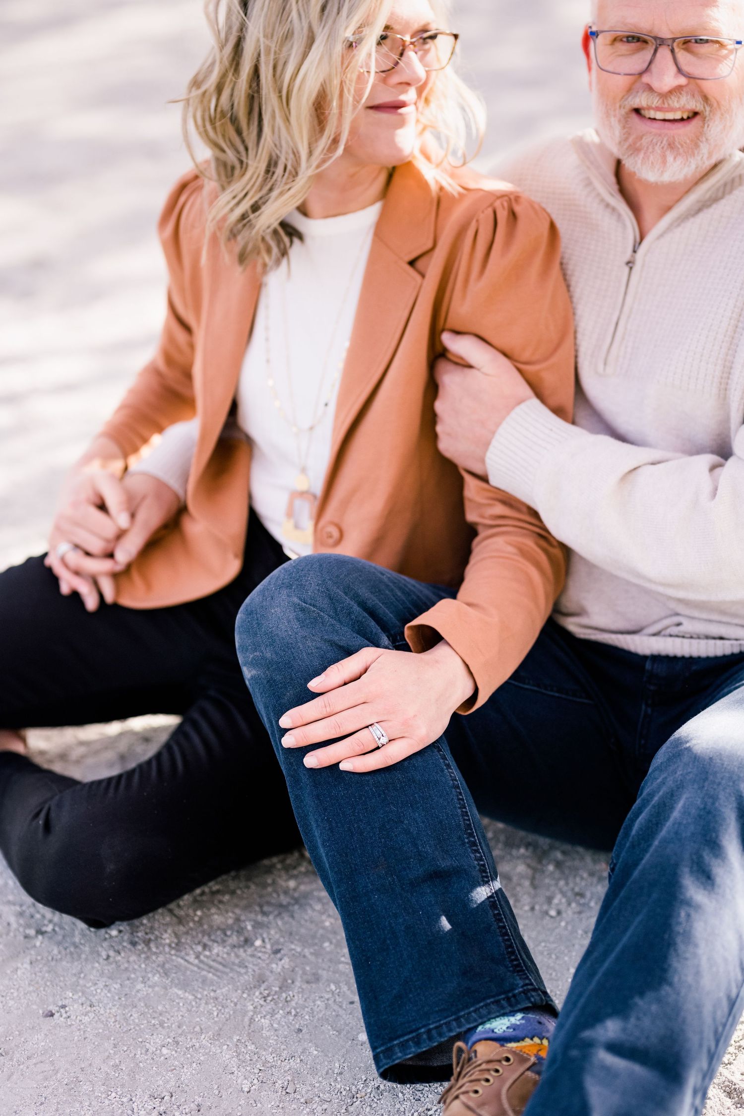 Couple holds hands and snuggles close during their engagement session by utah wedding photographer Coley Cook