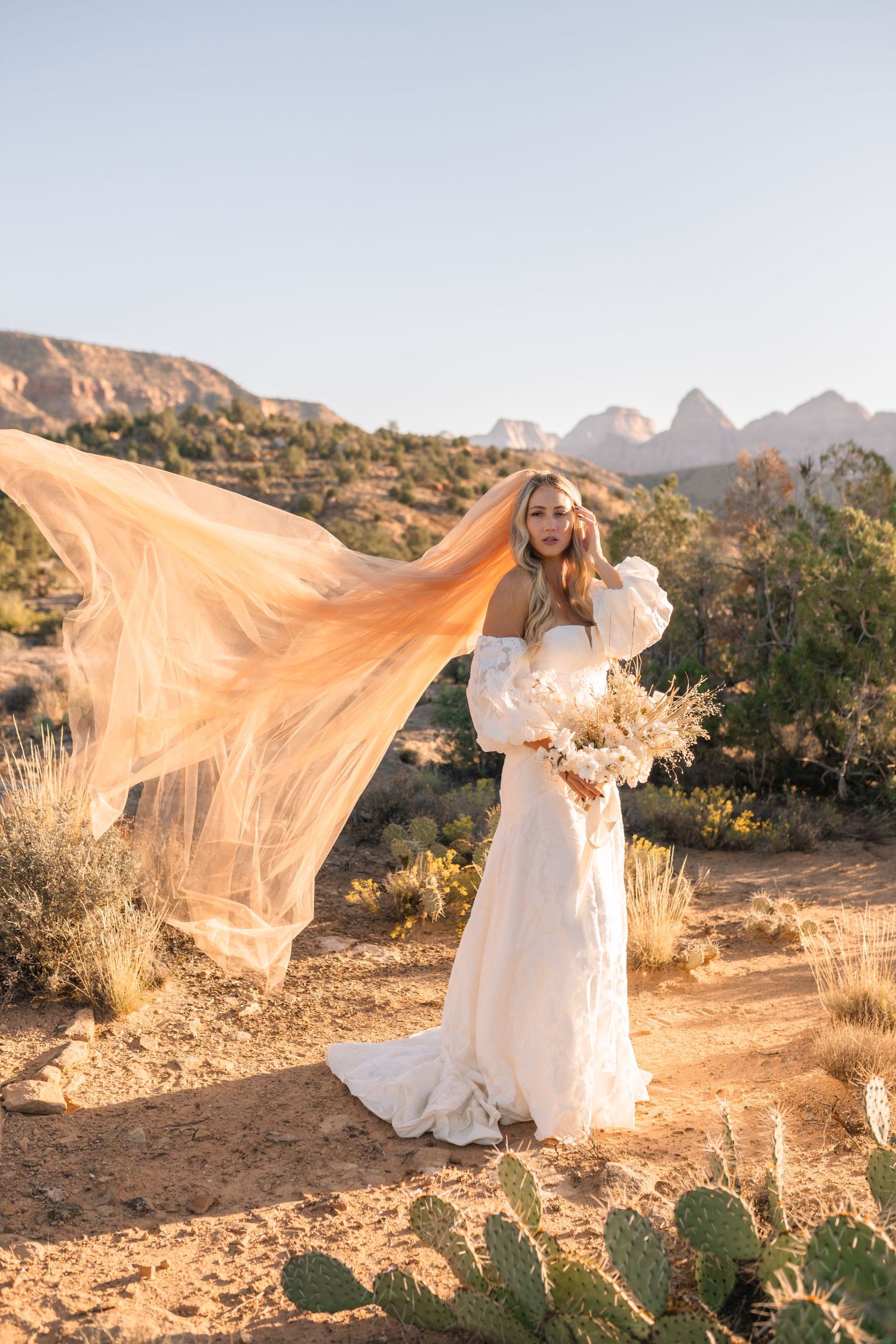 Zions wedding photographer takes beautiful desert sunrise bridals featuring a unique veil and dried floral bouquet.