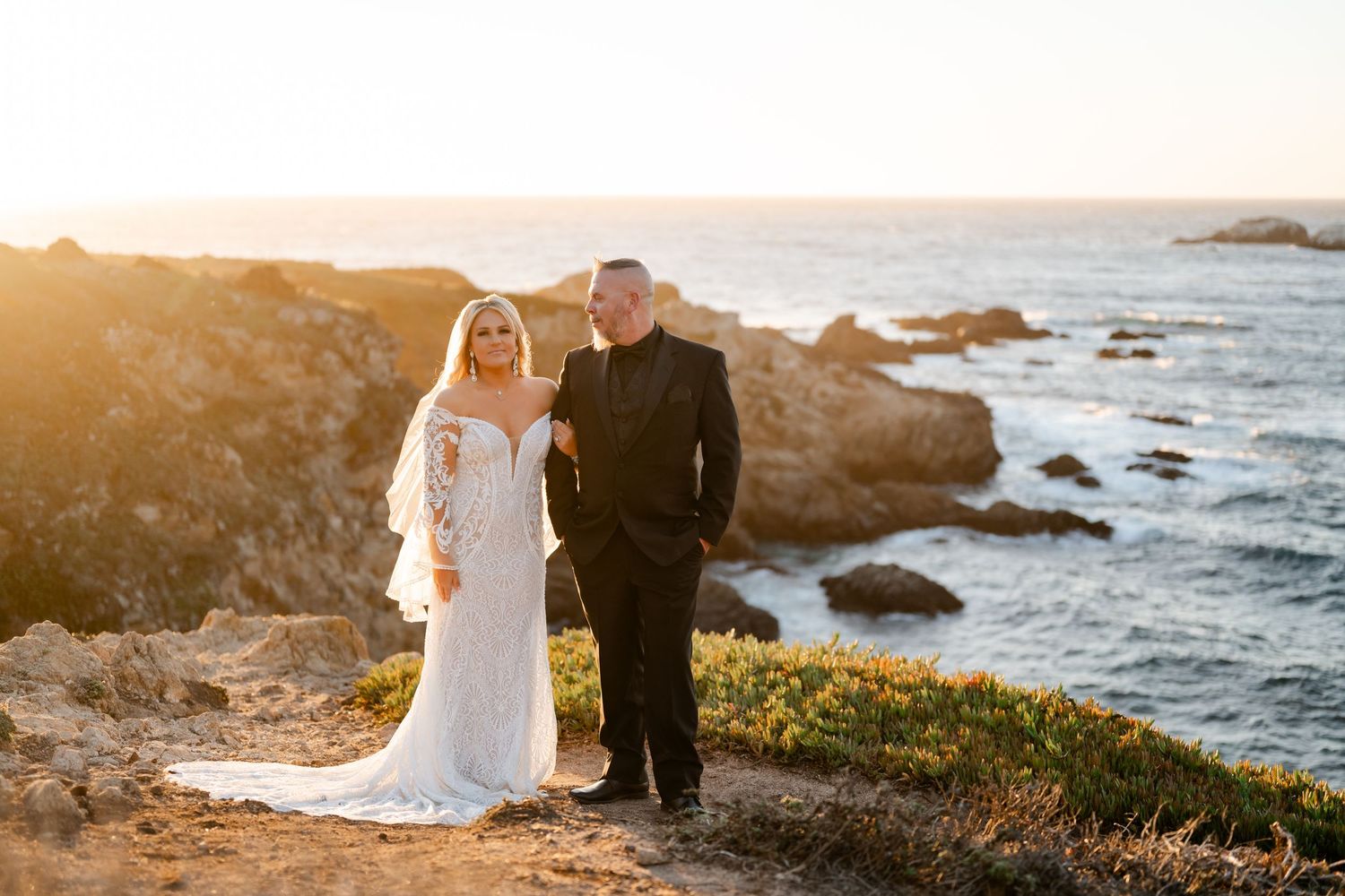 Romantic sunset wedding photography session on rocky California coastline.