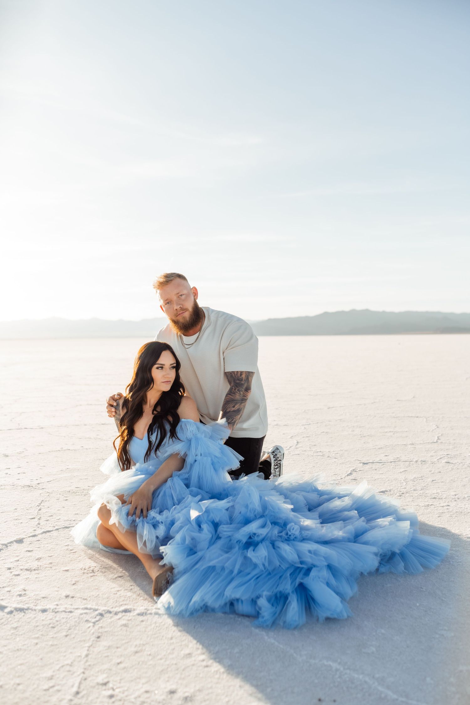 Couple hold each other during Salt Flats photos by Utah couples photographer during sunset