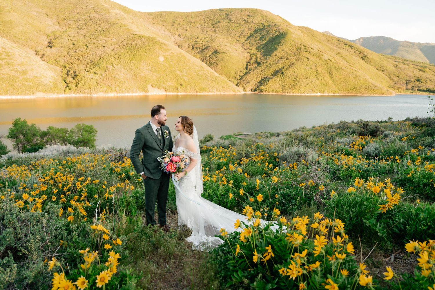 Wedding photography series capturing couple's romantic moments in mountain meadow with yellow wildflowers.