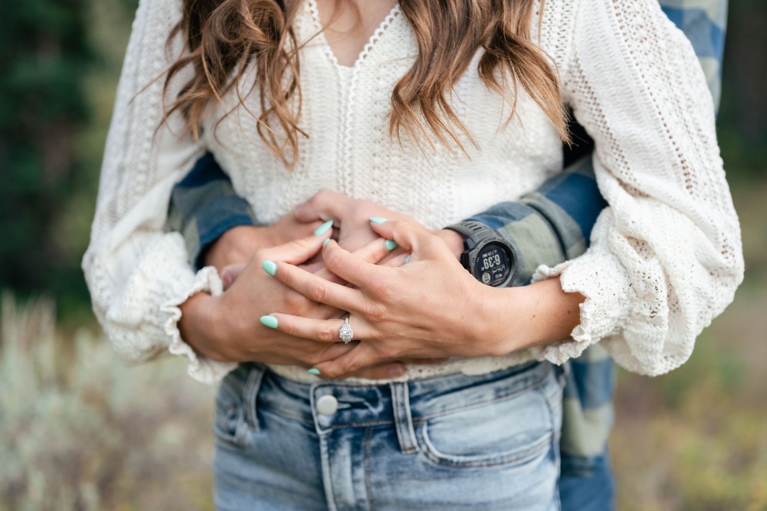 Close-up of embracing couple wearing casual autumn attire.