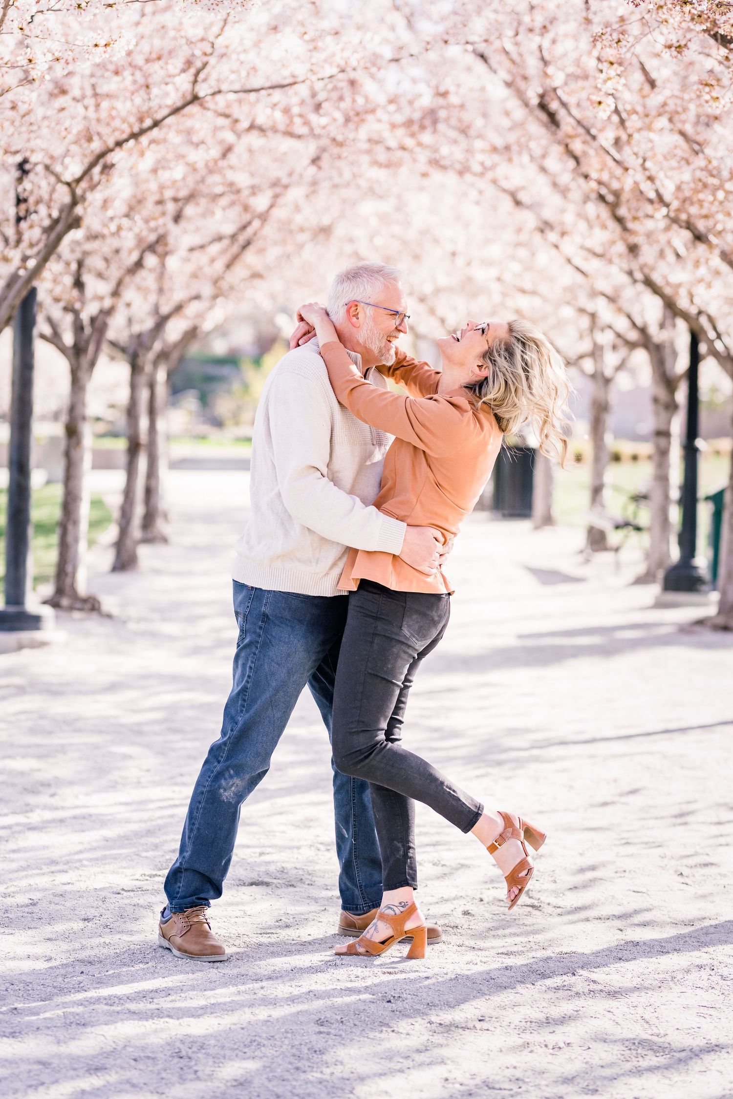 Couple laughs at the Capitol blossoms by Utah engagement photographer Coley Cook