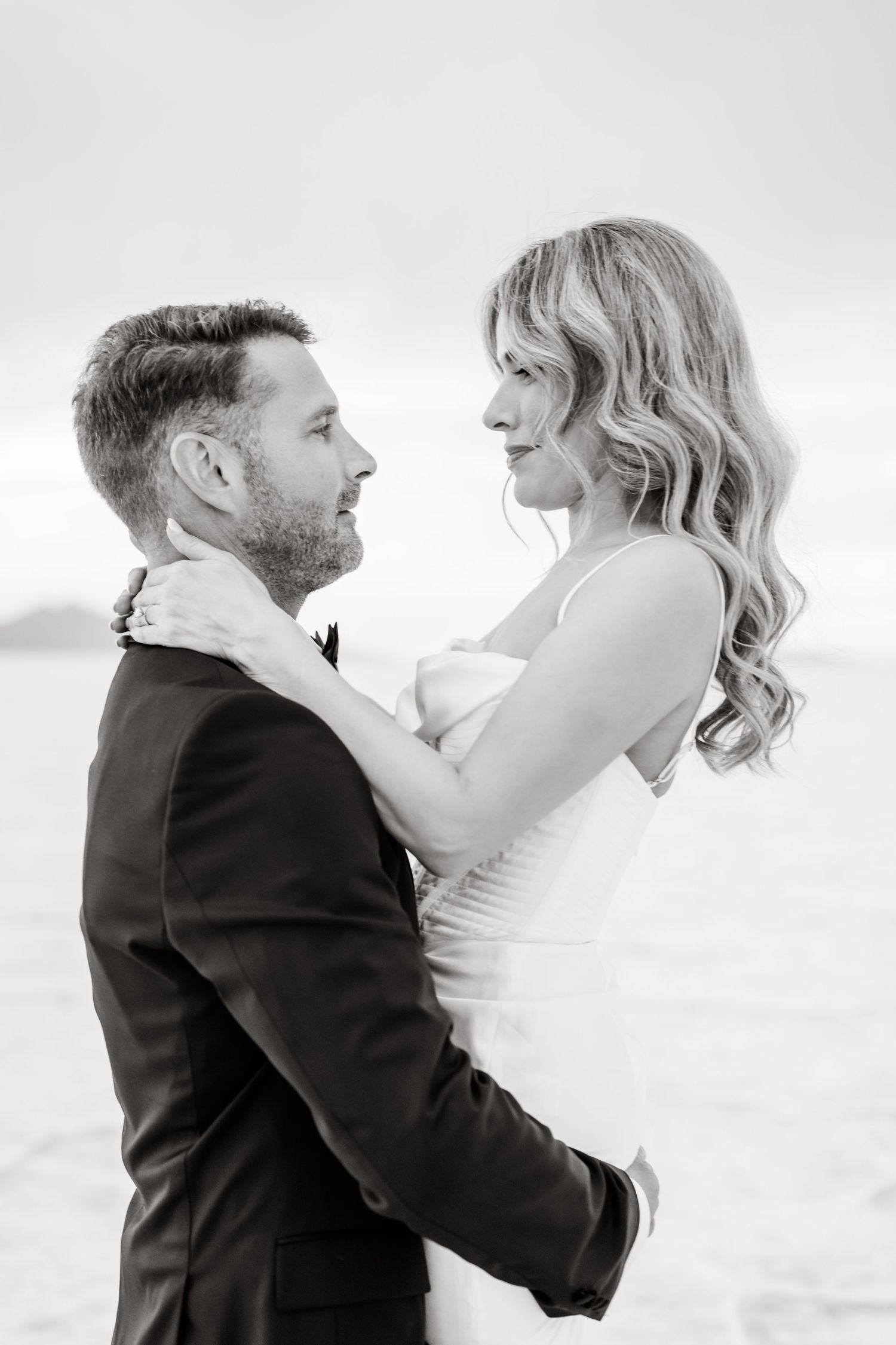 Salt Flats Elopement Photographer. A romantic black and white portrait series of a couple embracing on their wedding day.