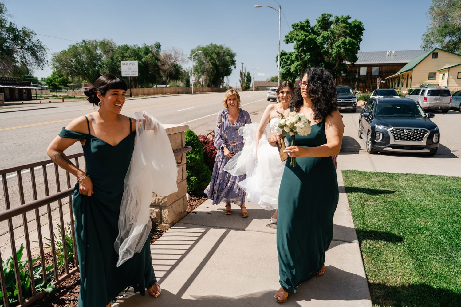 A series of candid moments at an outdoor wedding celebration showing guests and wedding party in dark teal dresses.