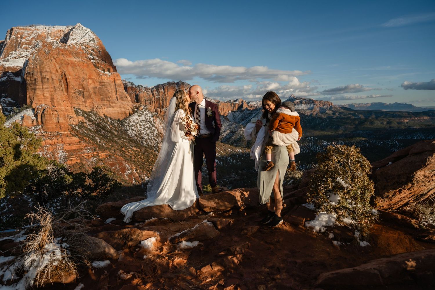 Panoramic vista of Zion National Park's majestic red rock formations against a bright blue sky.