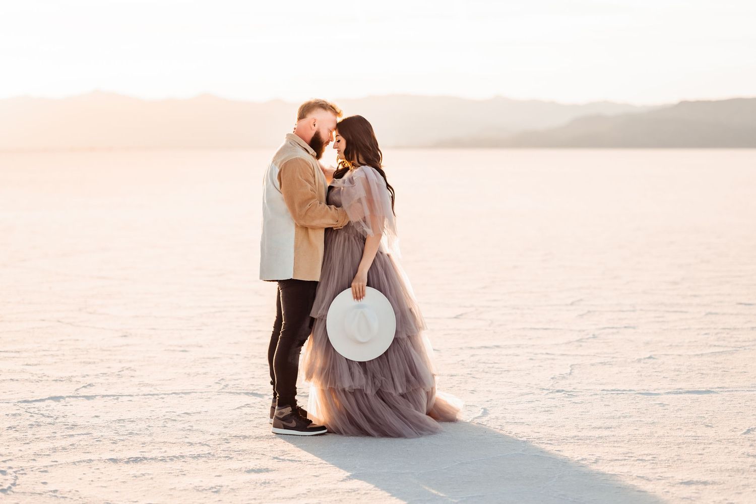 Salt Flats photos of a couple during sunset by Utah engagements photographer