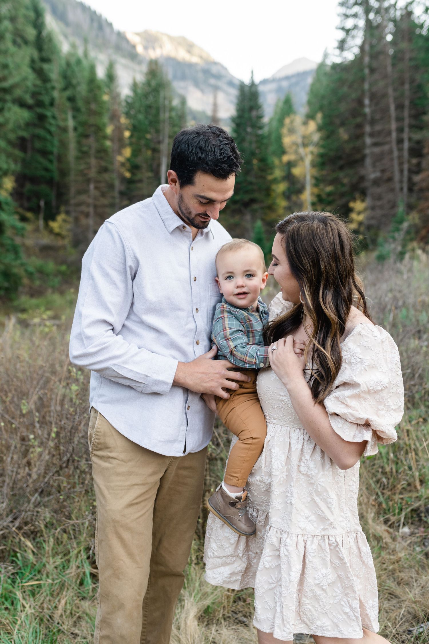 young family has a close cuddle together in American Fork Canyon for their fall family photos