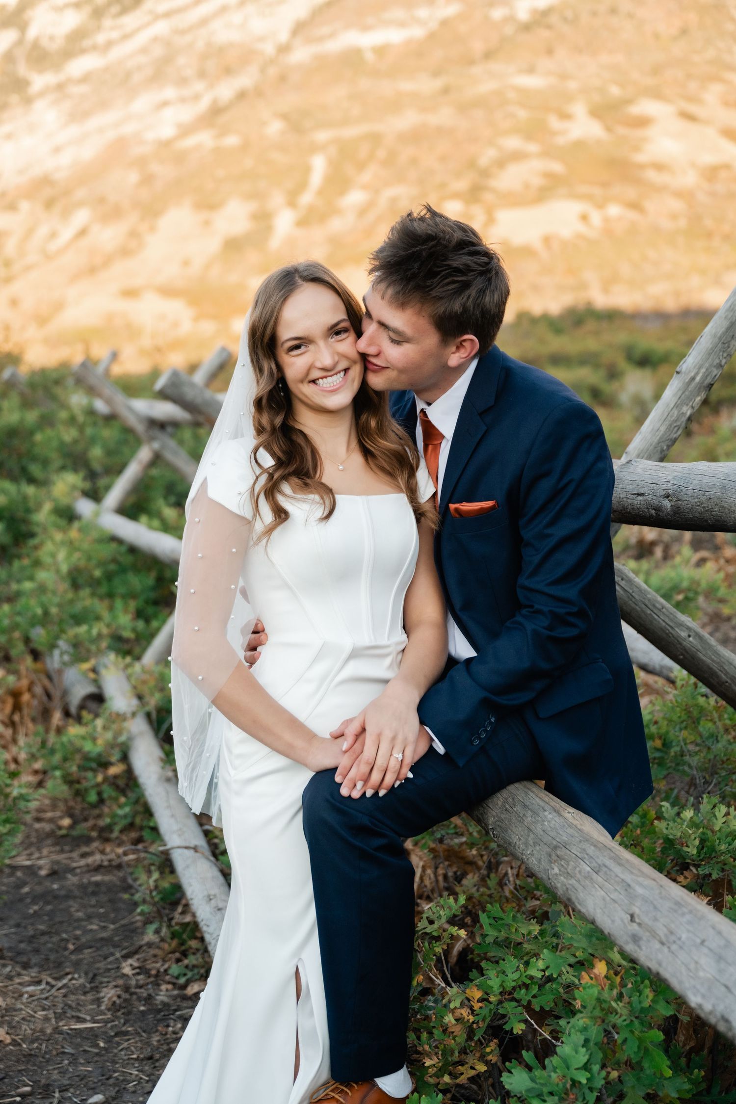 Wedding couple in the mountains at golden hour laughing together. Utah Wedding photographer Coley Cook.